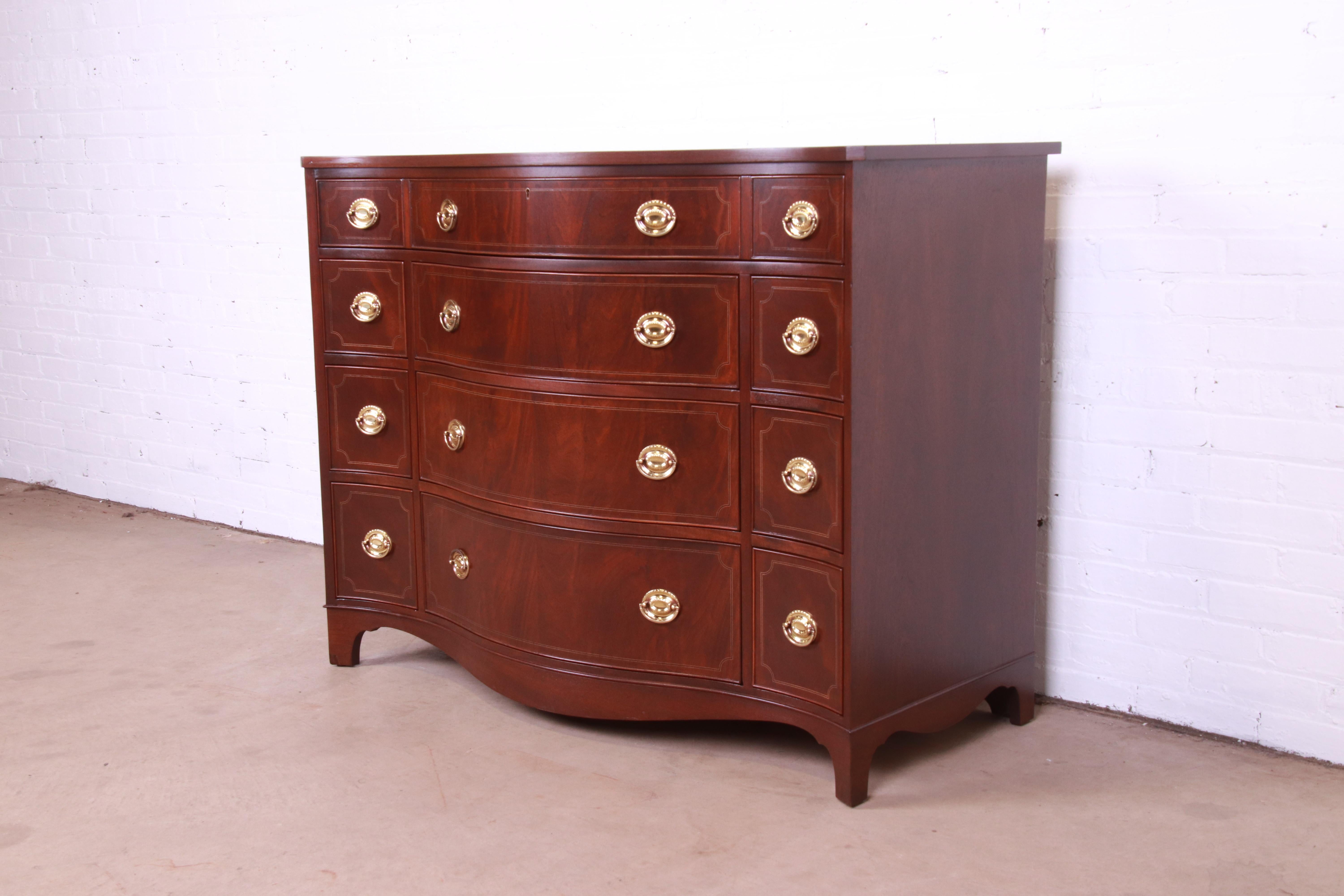 A gorgeous Georgian style serpentine front ten-drawer dresser, commode, or chest of drawers

By Baker Furniture, 
