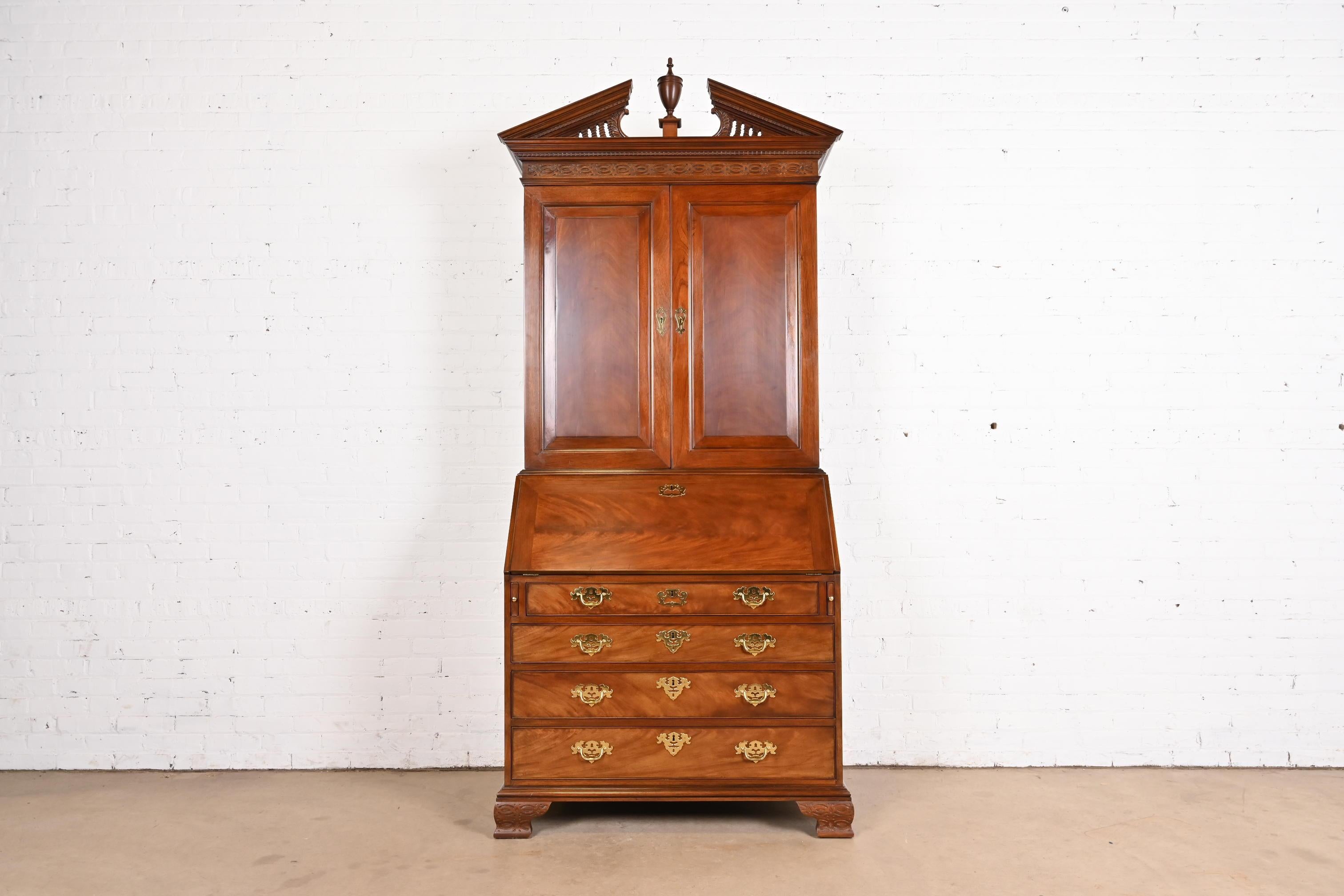 A beautiful Georgian or Chippendale style bureau with drop front secretary desk and bookcase hutch top

By Baker Furniture, 