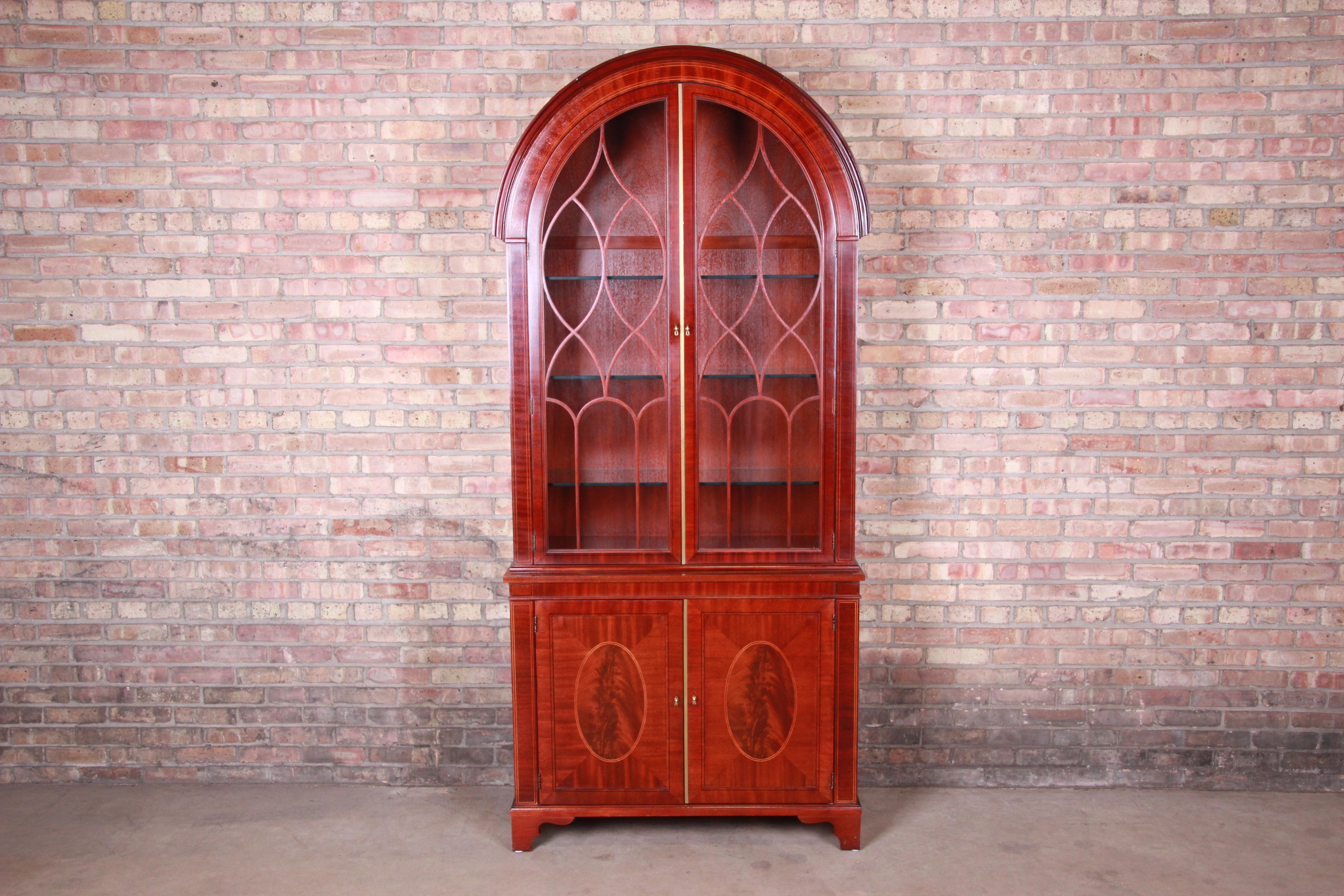 An exceptional Georgian style arched top lighted bookcase or display cabinet

By Baker Furniture 