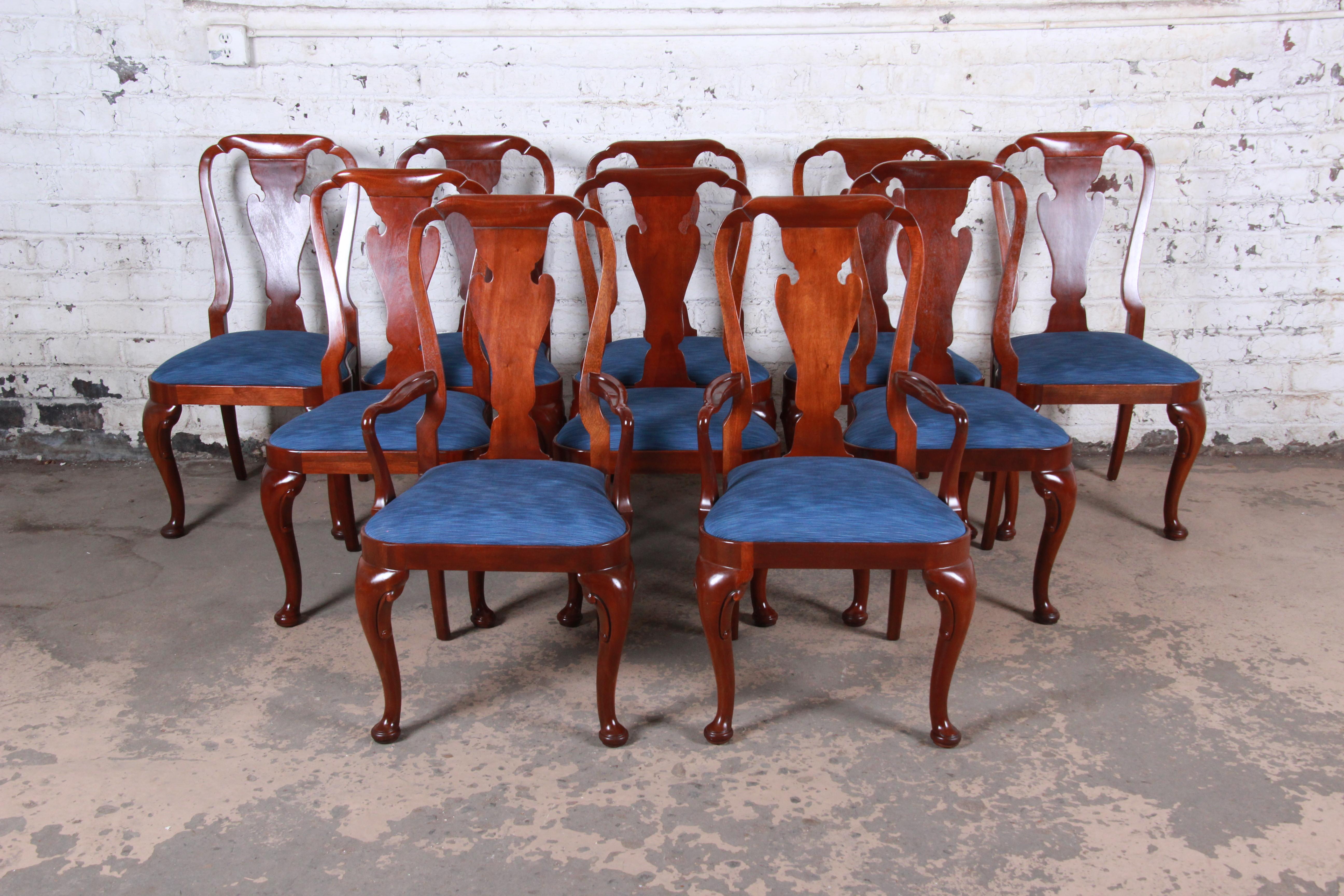 A gorgeous set of ten Queen Anne style carved mahogany dining chairs

By Baker Furniture 
