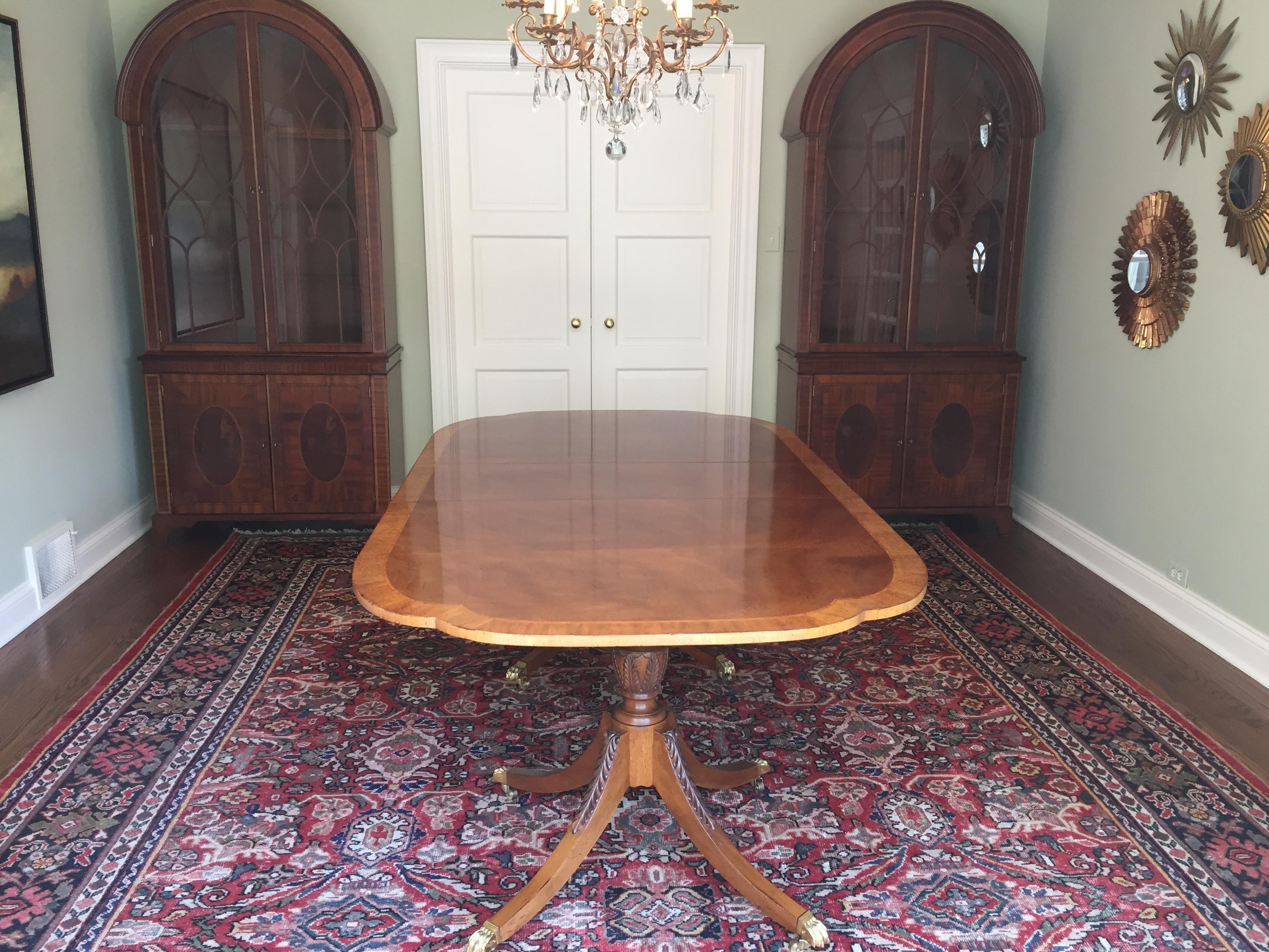 Baker furniture historical Charleston collection 
This elegant dining table has two pedestals with brass capped feet, three leaves and $1000 of custom Baker pads 

Meaasures: 70 wide, with three leaves that are 16.25 each
102