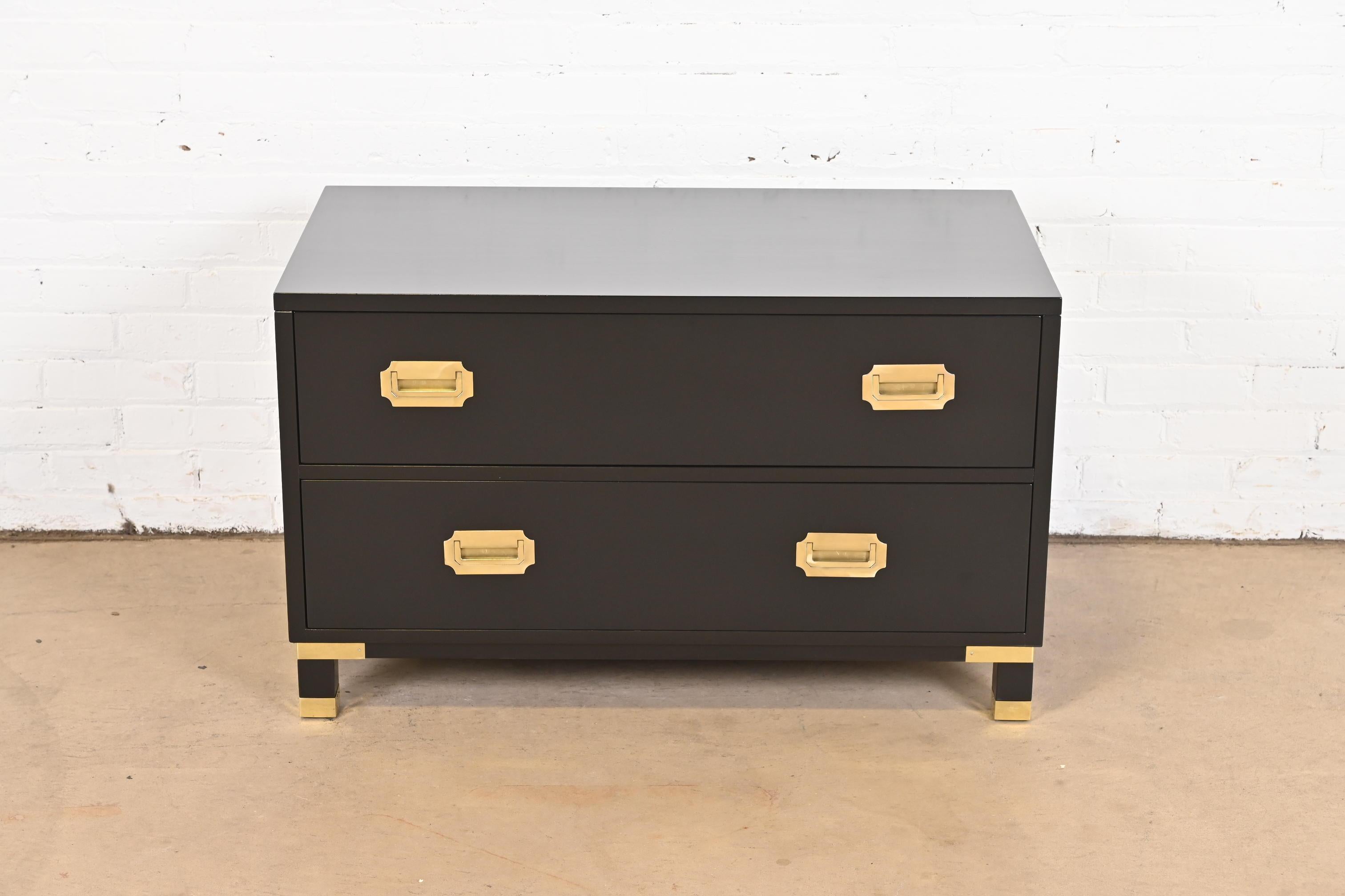 An exceptional Mid-Century Modern Hollywood Regency Campaign style two-drawer lowboy dresser or chest of drawers

By Baker Furniture, 