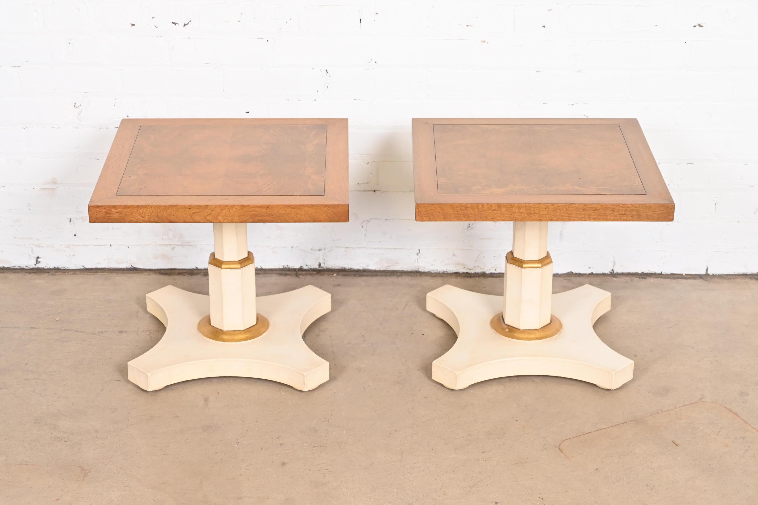 A gorgeous pair of Mid-Century Modern Hollywood Regency pedestal tea tables or occasional side tables

By Baker Furniture

USA, circa 1960s

Beautiful burled walnut tops, with cream and gold gilt painted bases.

Measures: 18