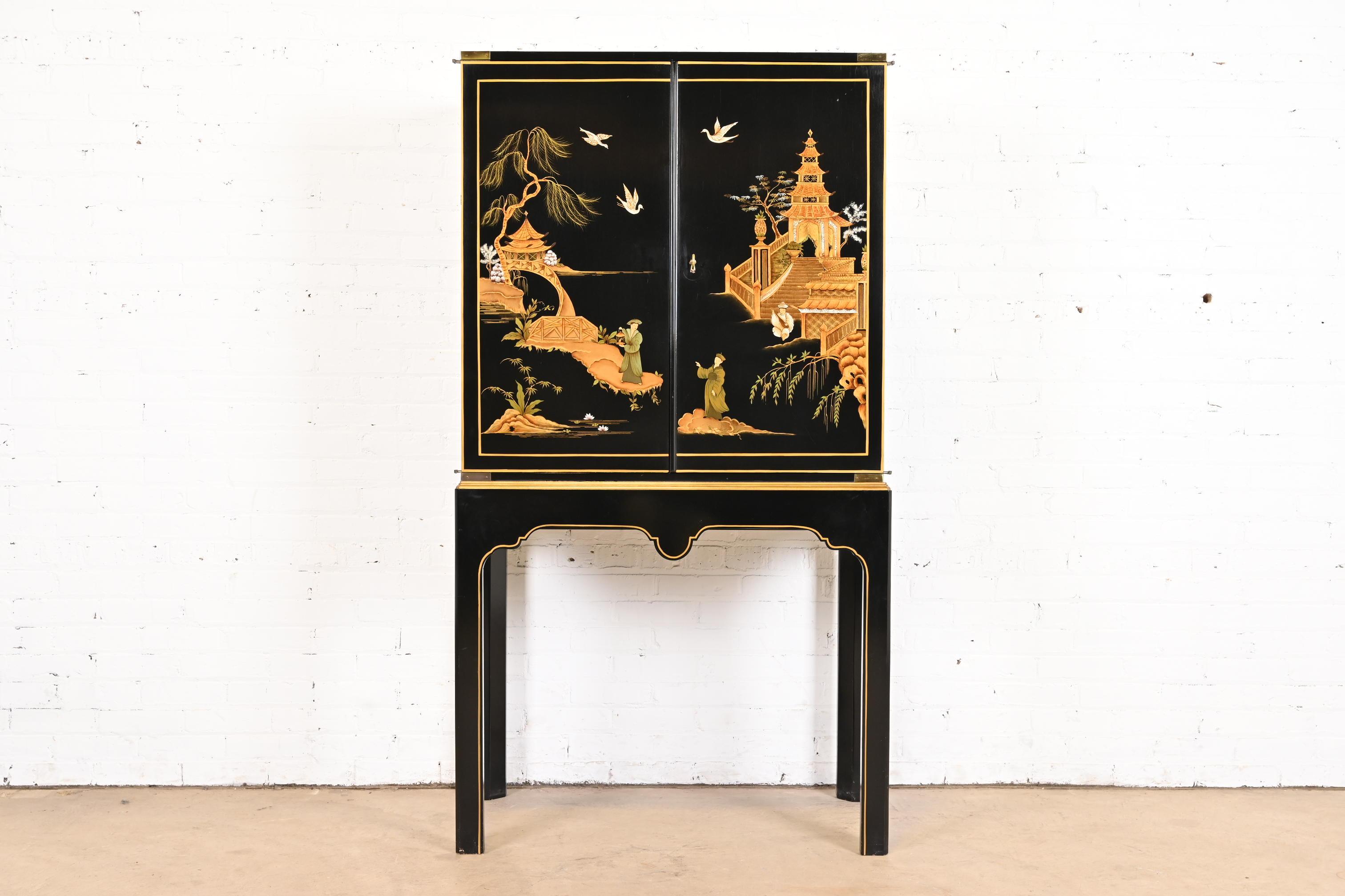 A gorgeous Hollywood Regency Chinoiserie style bar cabinet

By Baker Furniture

USA, Circa 1980s

Black lacquered mahogany, with gold gilt trim, hand painted Asian scenes, and original brass hardware.

Measures: 36.75