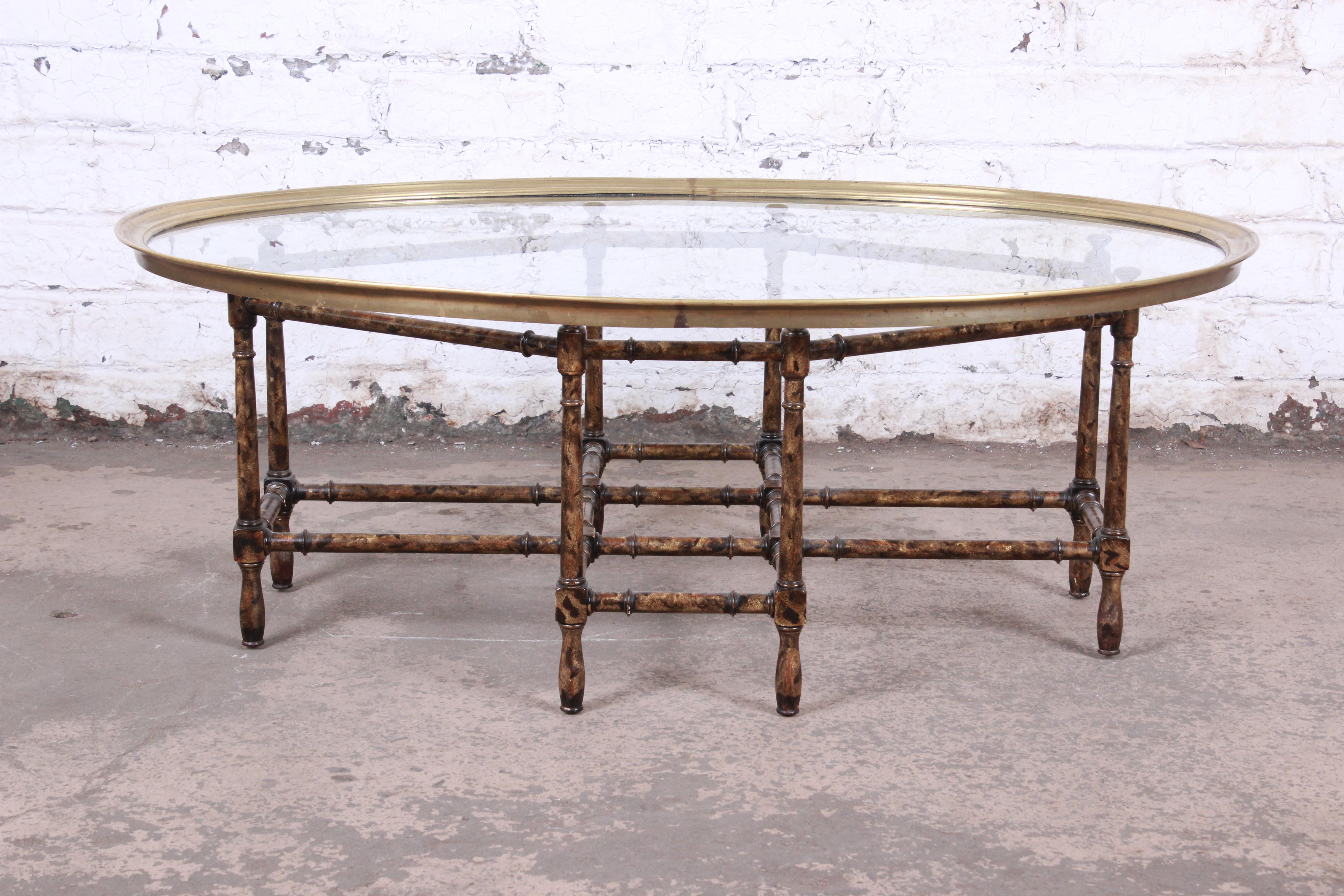 A gorgeous Mid-Century Modern Hollywood Regency chinoiserie faux bamboo coffee or cocktail table

By Baker Furniture

USA, circa 1970s

Base in faux bamboo with tortoiseshell finish. Tabletop in brass and glass.

Measures: 44.25