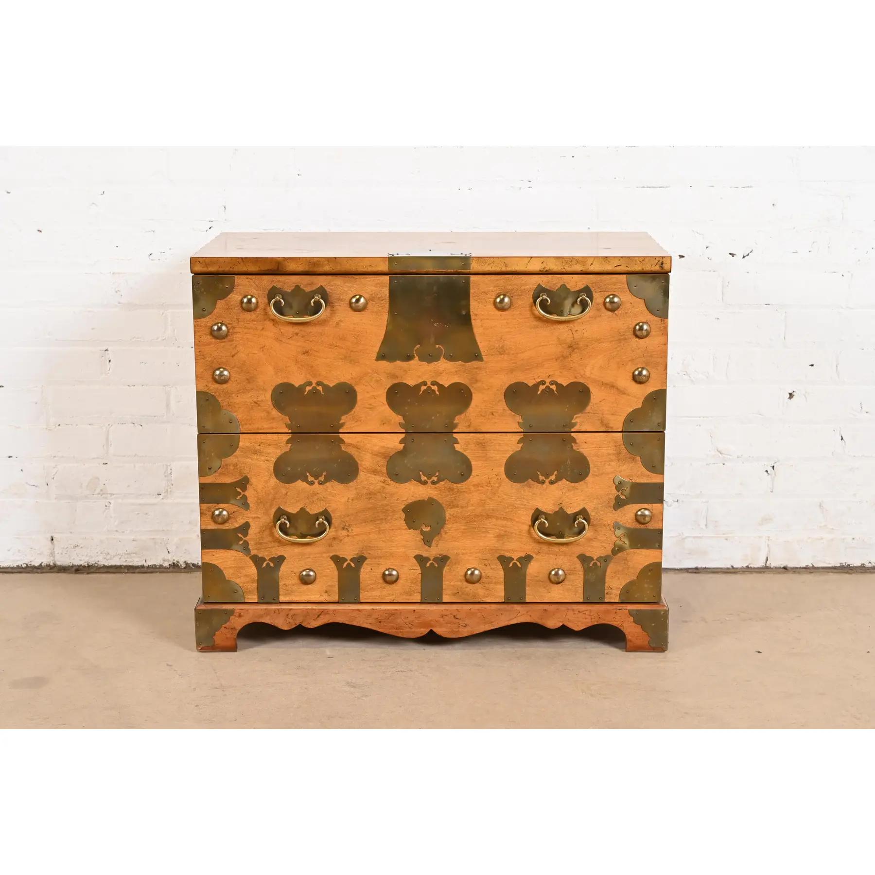 A gorgeous mid-century modern Hollywood Regency Chinoiserie Korean Tansu style nightstand, commode, or chest of drawers

By Baker Furniture

USA, Circa 1970s

Carved walnut, with original Asian-inspired brass hardware and accents, and unique exposed