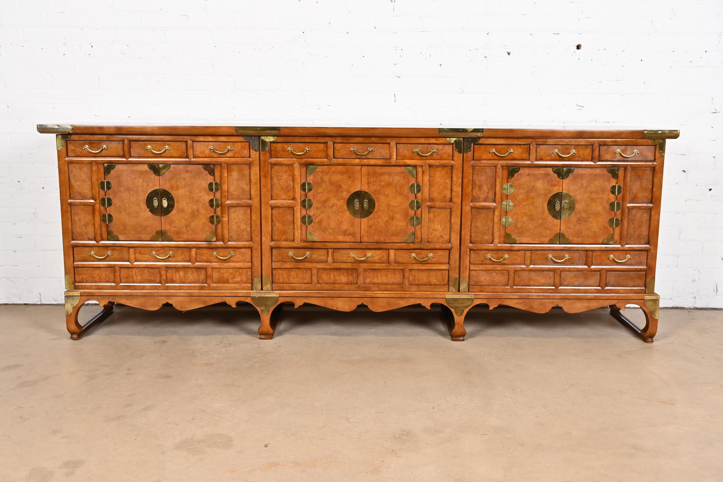 An outstanding mid-century modern Hollywood Regency Chinoiserie monumental sideboard, credenza, or bar cabinet

By Baker Furniture

USA, Circa 1960s

Gorgeous burled walnut, with original brass hardware.

Measures: 100
