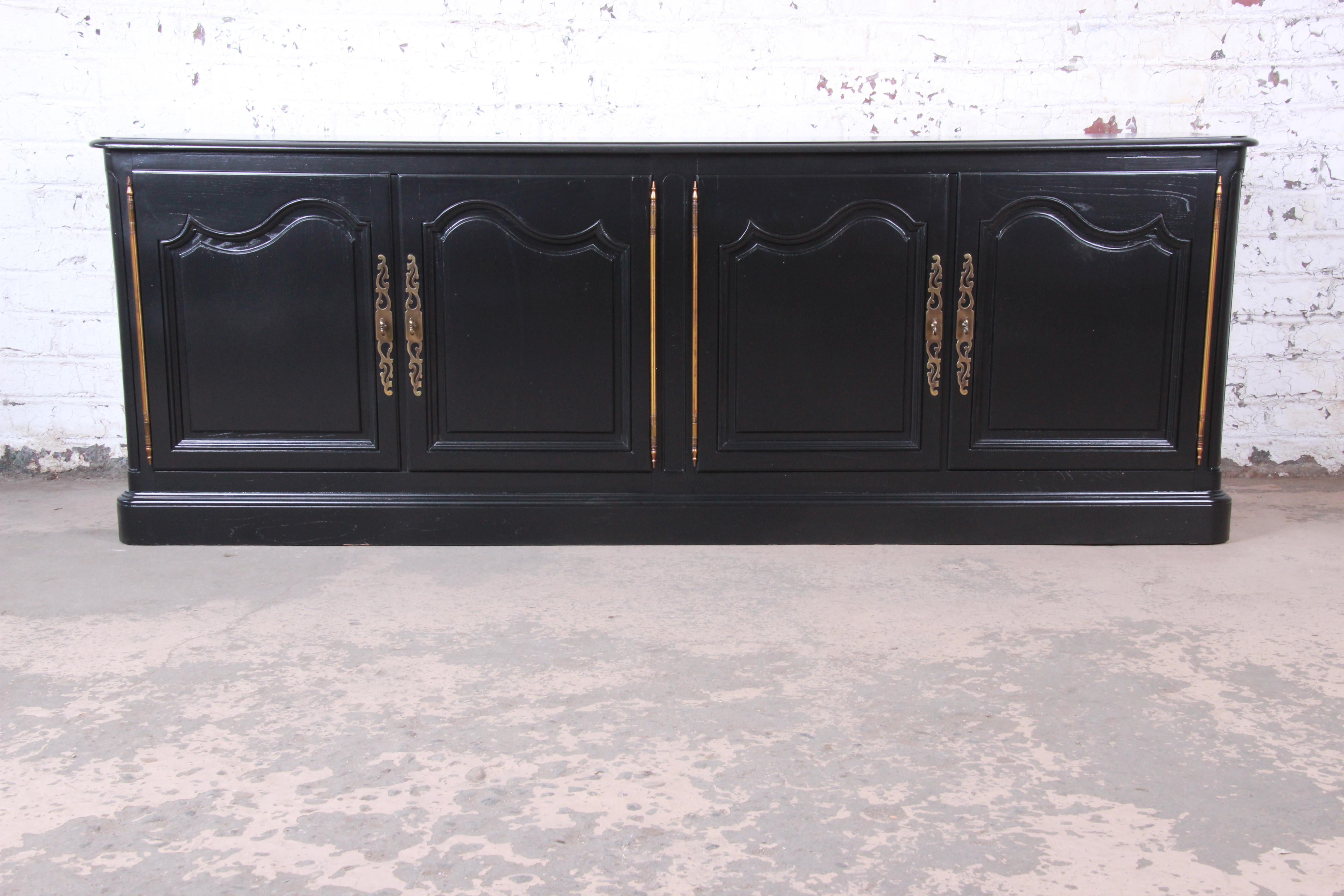 A gorgeous Mid-Century Modern Hollywood Regency ebonized sideboard, credenza, or bar cabinet

By Baker Furniture

USA, circa 1960s

Newly ebonized oak and original brass hardware

Measures: 90.13