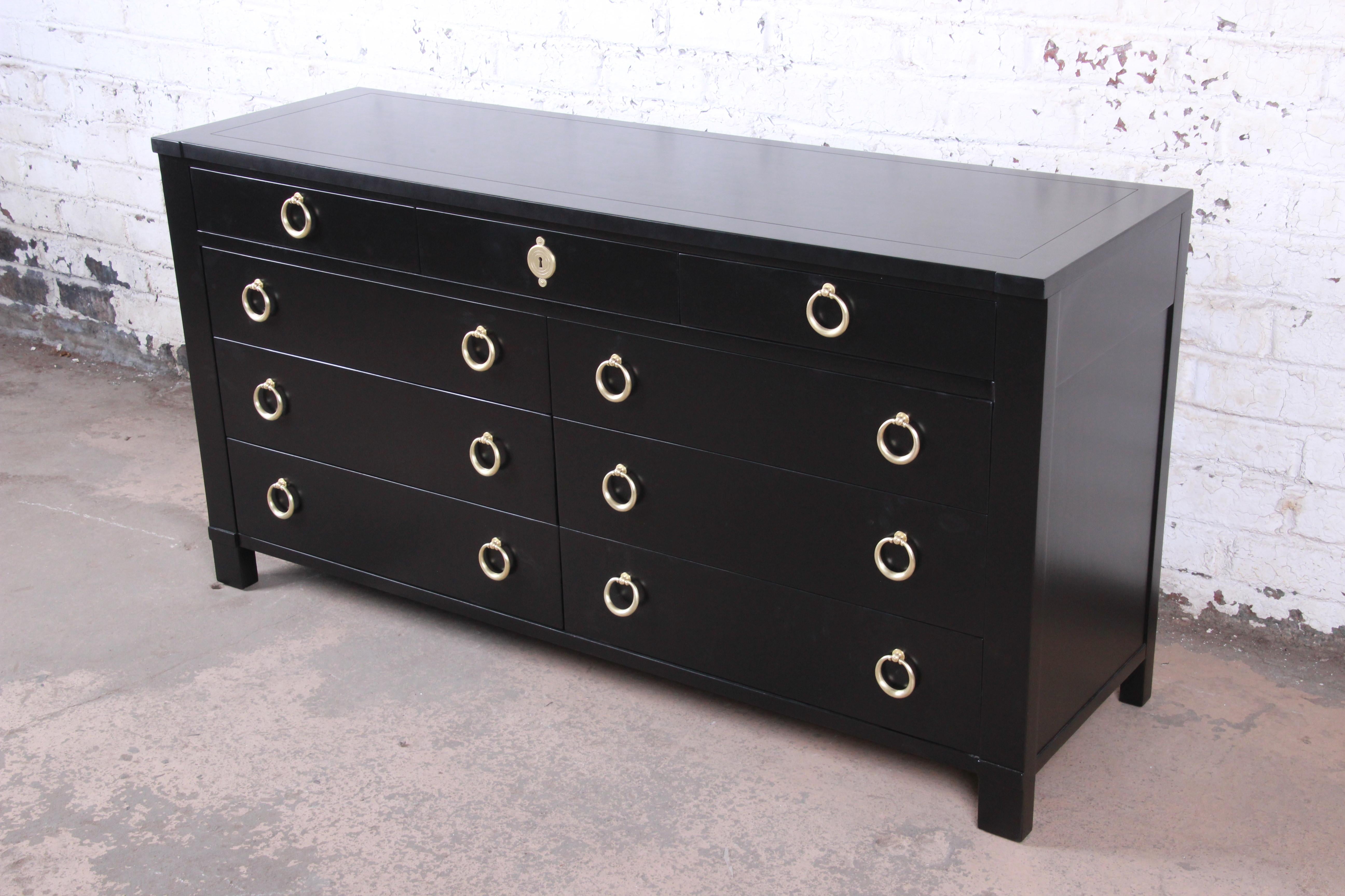 An exceptional midcentury Hollywood Regency nine-drawer dresser or credenza

By Baker Furniture

USA, circa 1960s

cherrywood, lacquer and brass hardware

Measures: 62.5