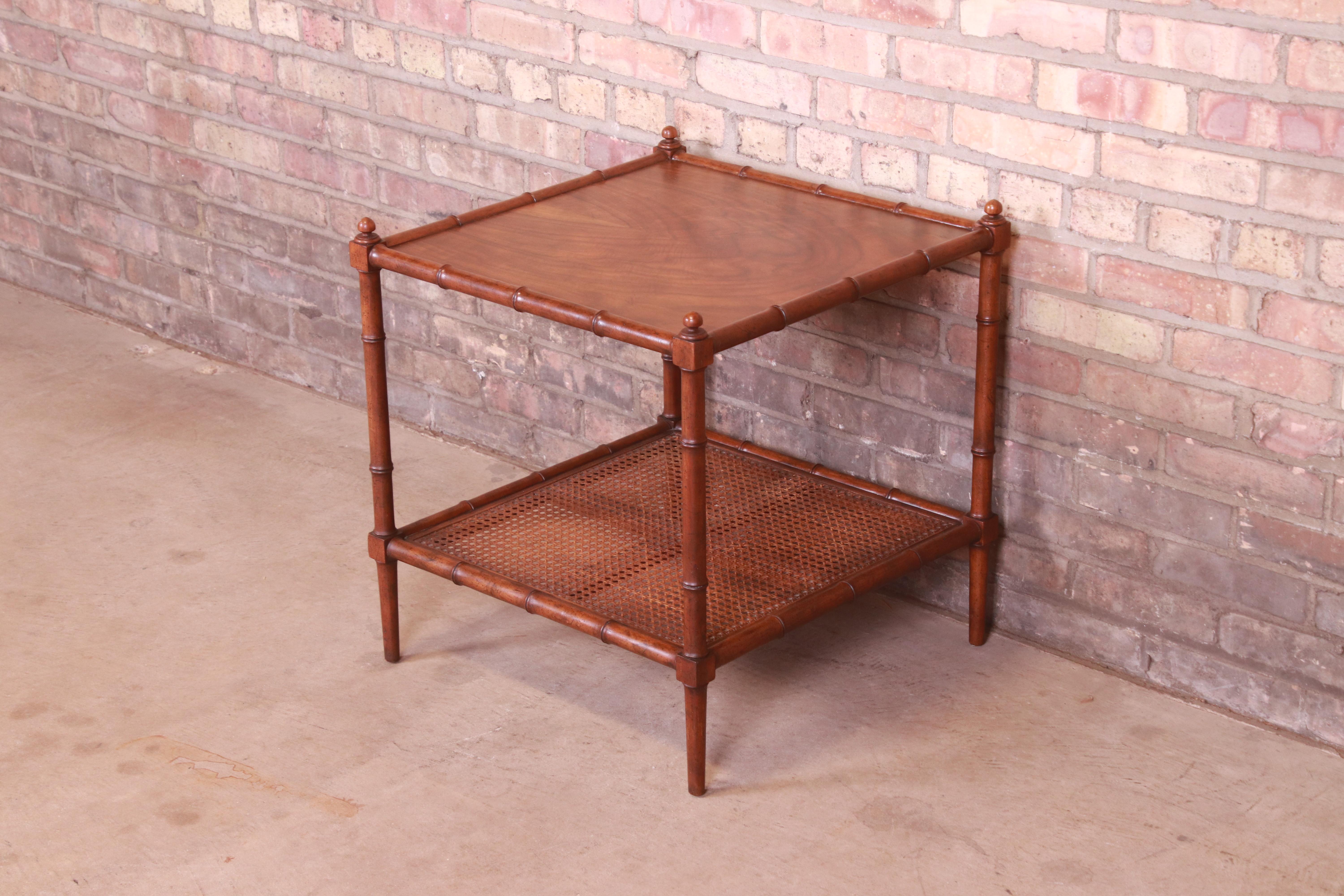 A gorgeous Mid-Century Modern Hollywood Regency Chinoiserie two-tier side table

By Baker Furniture

USA, Circa 1960s

Walnut, with carved faux bamboo legs and trim and cane shelf.

Measures: 22