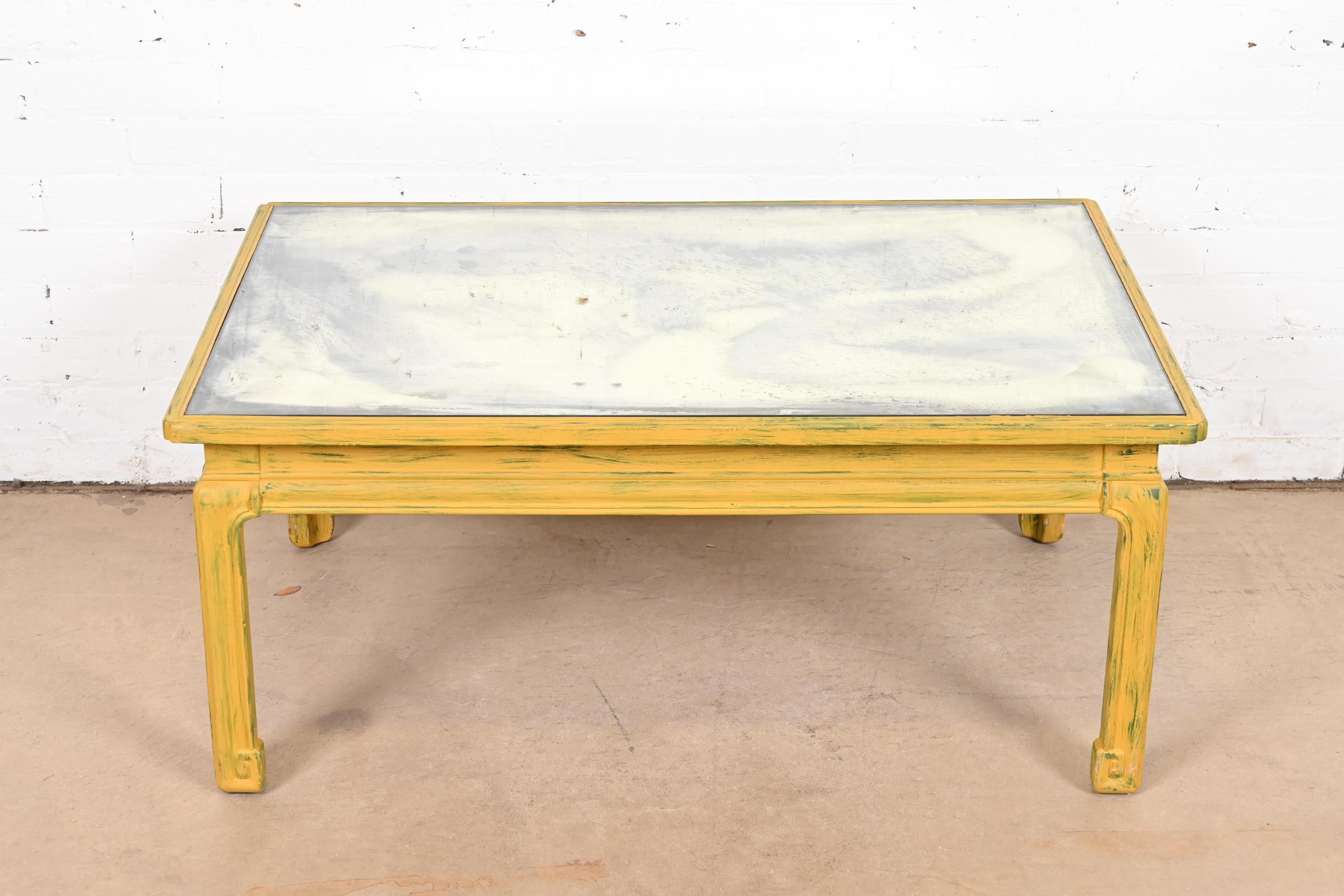 A gorgeous Hollywood Regency Chinoiserie yellow lacquered coffee table with antiqued mirrored top

By Baker Furniture

USA, Circa 1940s

Carved yellow and green lacquered hardwood frame, with mirrored top.

Measures: 37.5