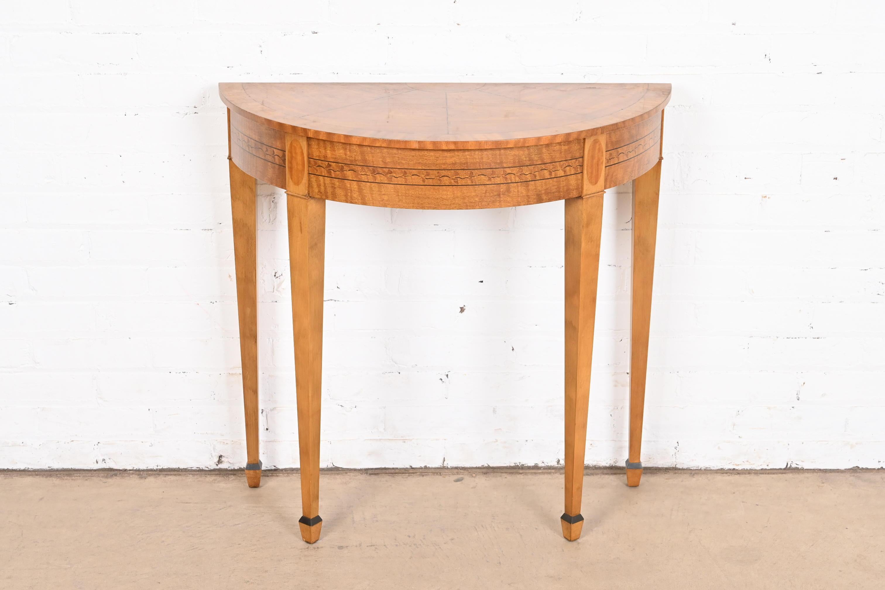 A gorgeous Federal style demilune console table or entry table

By Laura Ashley for Baker Furniture

USA, Circa 1990s

Mahogany, with inlaid floral marquetry.

Measures: 30