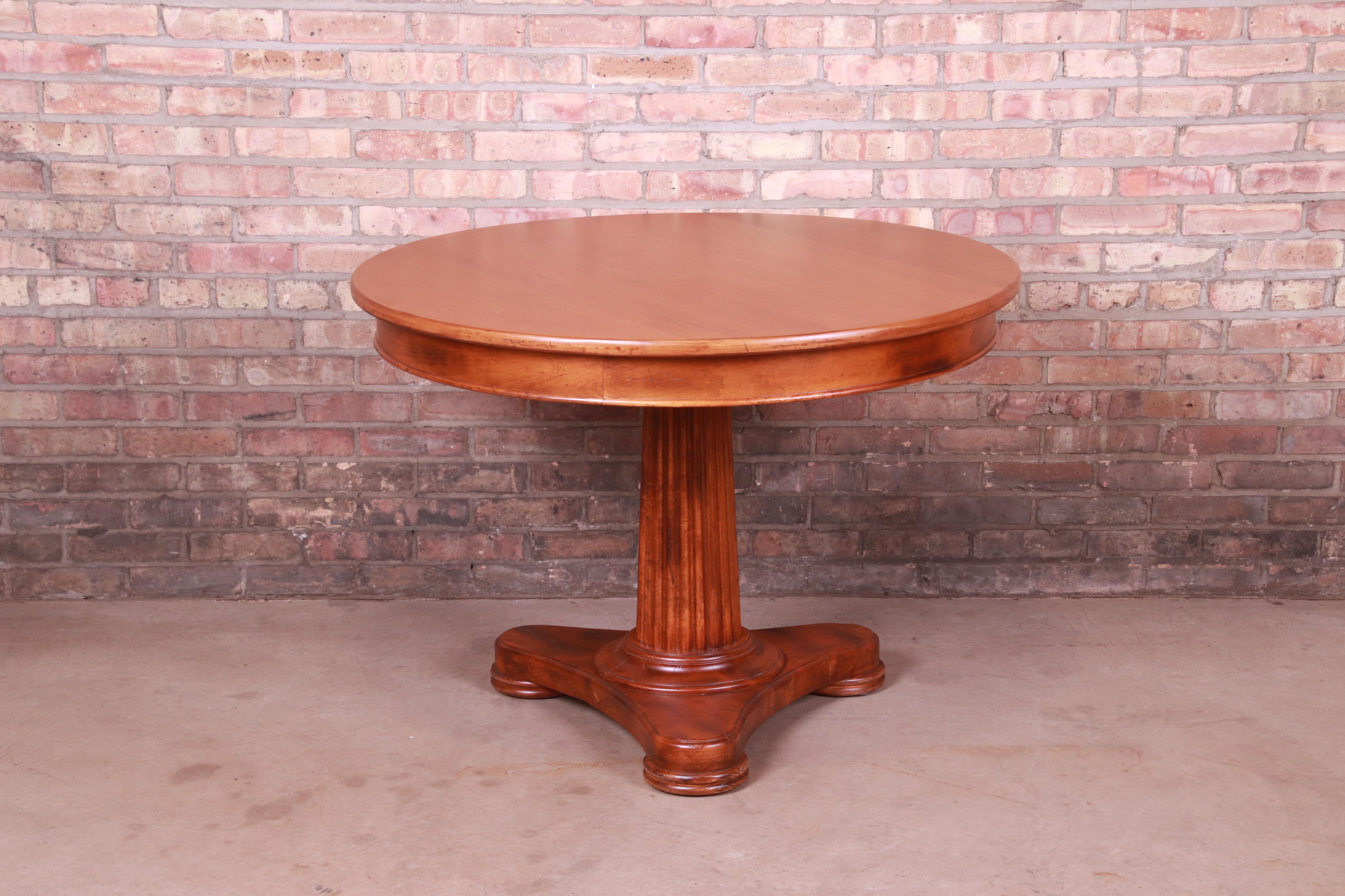 A gorgeous Italian Empire or Neoclassical style round pedestal breakfast table, game table, or center table

By Baker Furniture, 