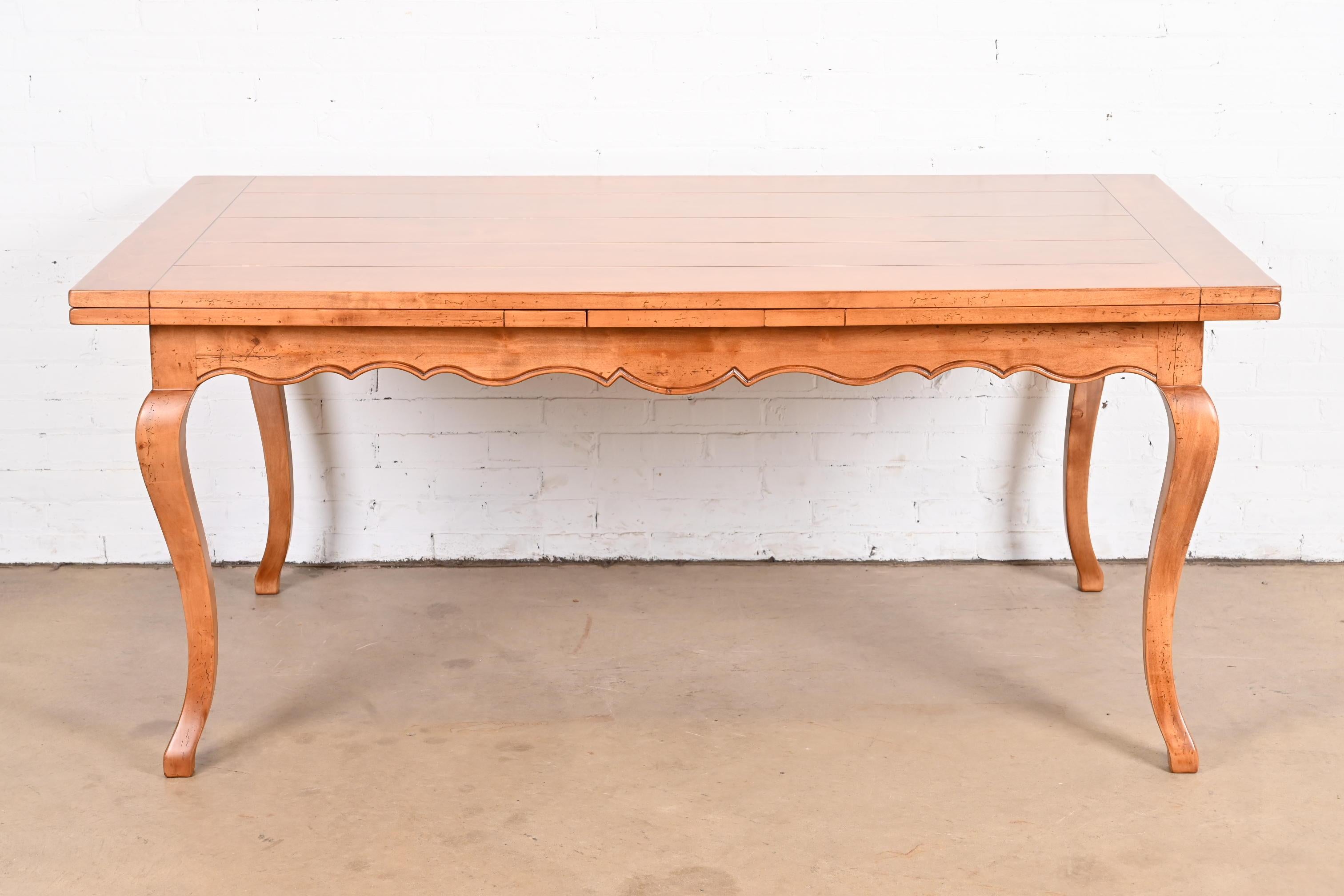An exceptional Italian Provincial or French Country maple extension harvest farmhouse dining table

By Baker Furniture, 