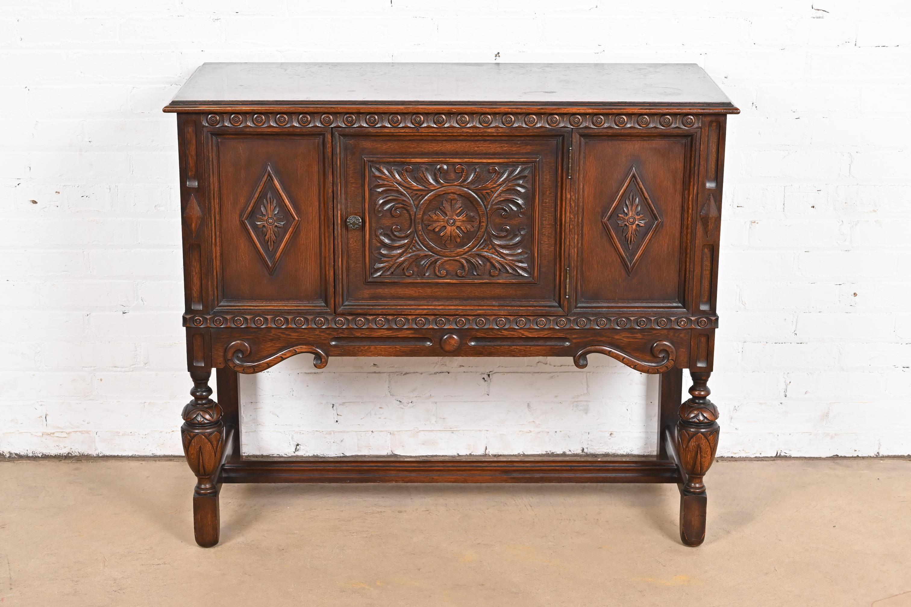 American Baker Furniture Jacobean Carved Oak Sideboard Buffet or Bar Cabinet, Circa 1920s