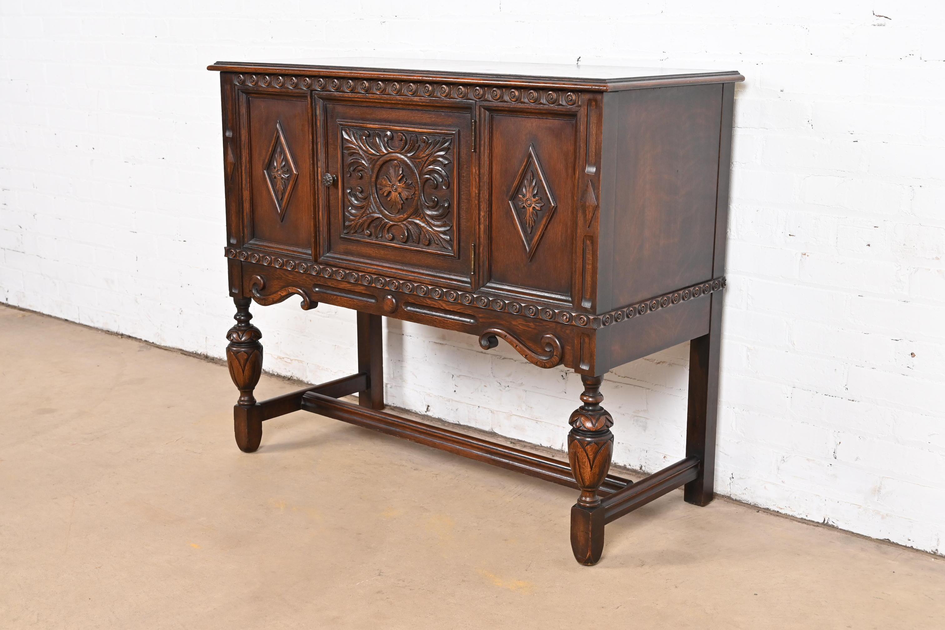Baker Furniture Jacobean Carved Oak Sideboard Buffet or Bar Cabinet, Circa 1920s In Good Condition In South Bend, IN