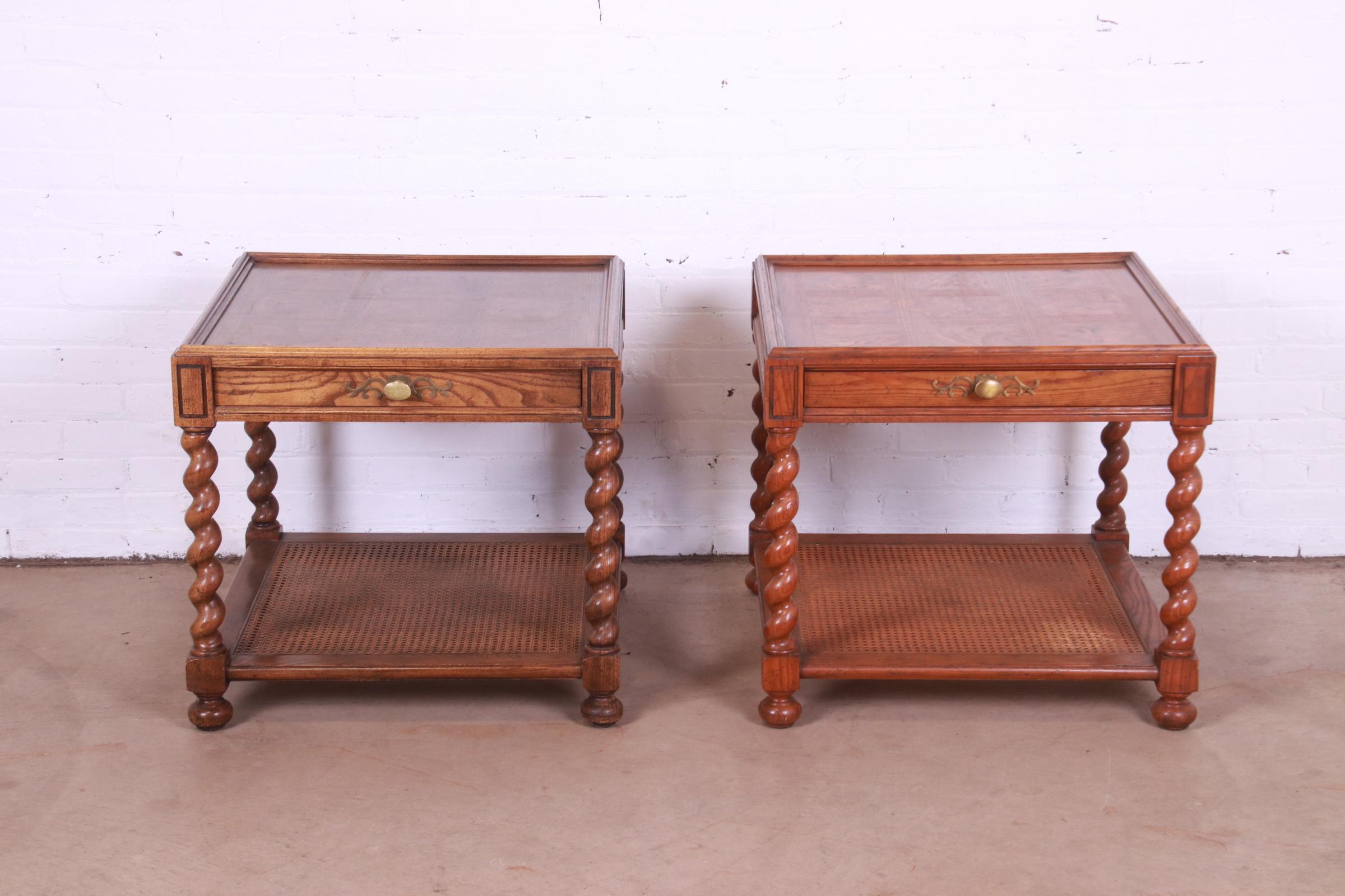 A gorgeous pair of Jacobean style English barley twist nightstands, tea tables, or occasional side tables with parquet top

By Baker Furniture

USA, Circa 1960s

Carved oak, with burl wood parquetry, caned lower shelf, and original brass
