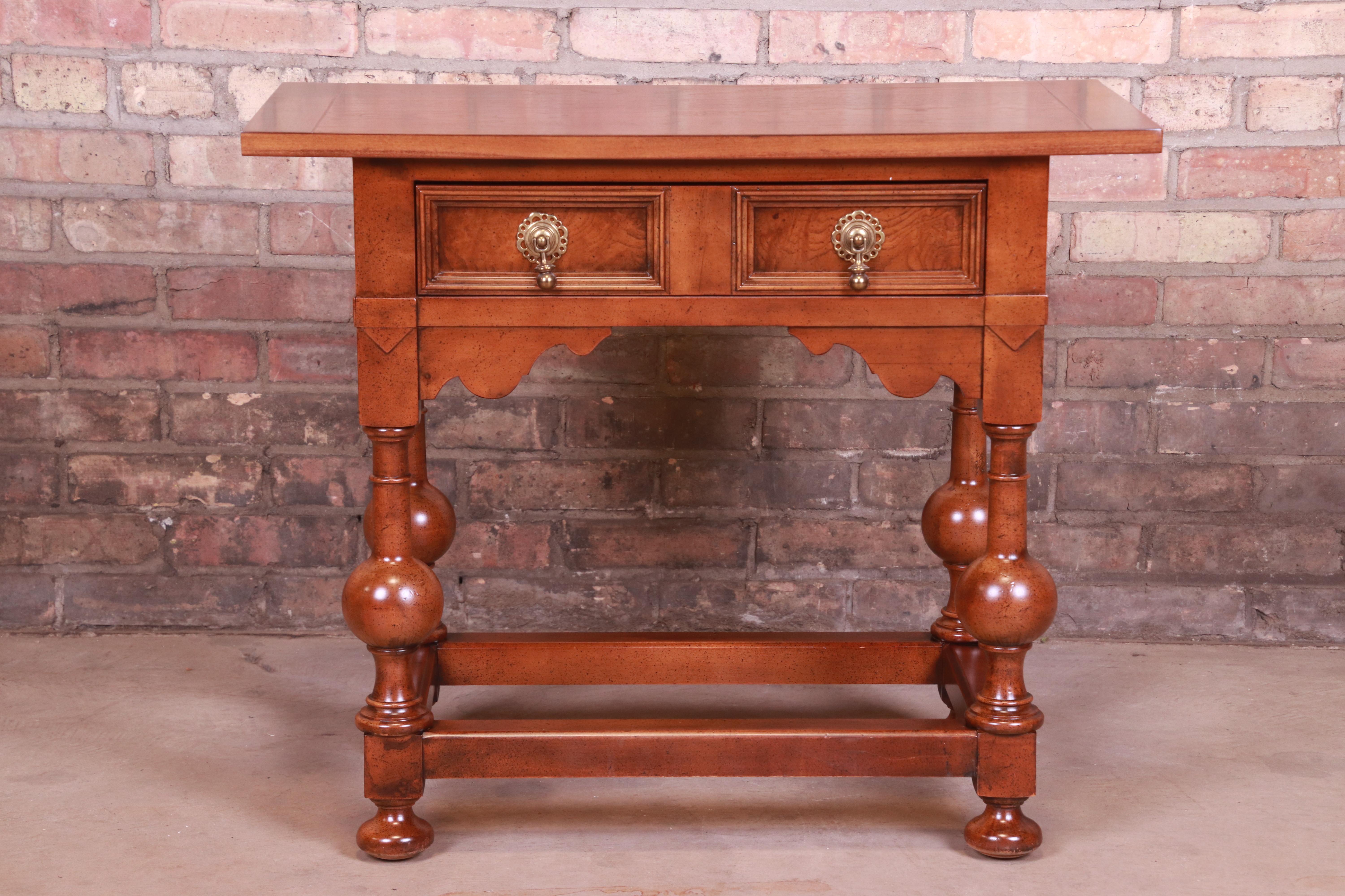 A gorgeous Jacobean style side table, entry table, or console

By Baker Furniture

USA, circa 1980s

Carved walnut, with burled walnut drawer fronts and original brass hardware.

Measures: 29.88