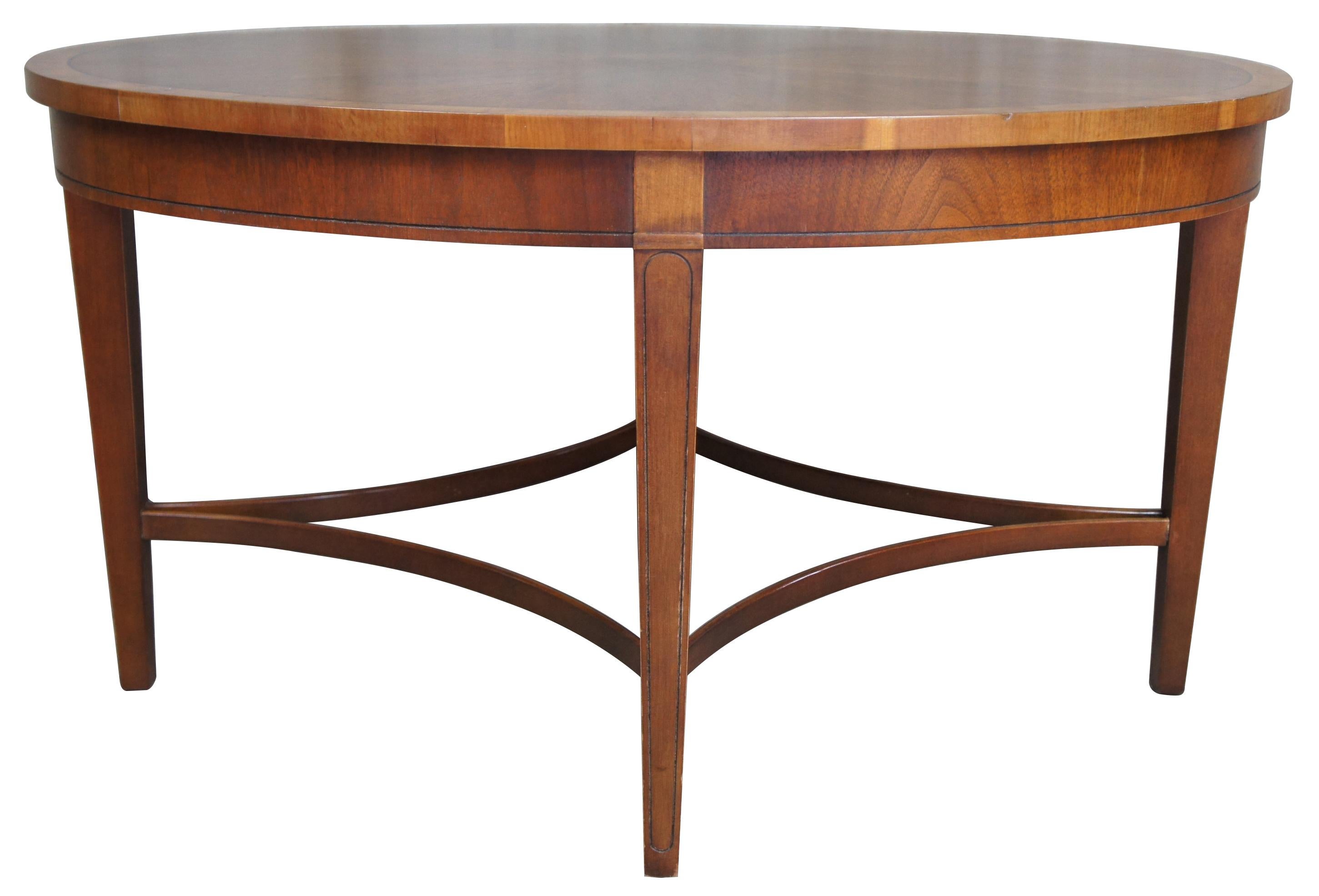 Baker Furniture Laura Ashley inlaid mahogany burl wood coffee table Sheraton

Oval shaped with banded top, made from mahogany with burl wood center. Tapered legs are connected by bentwood stretchers.