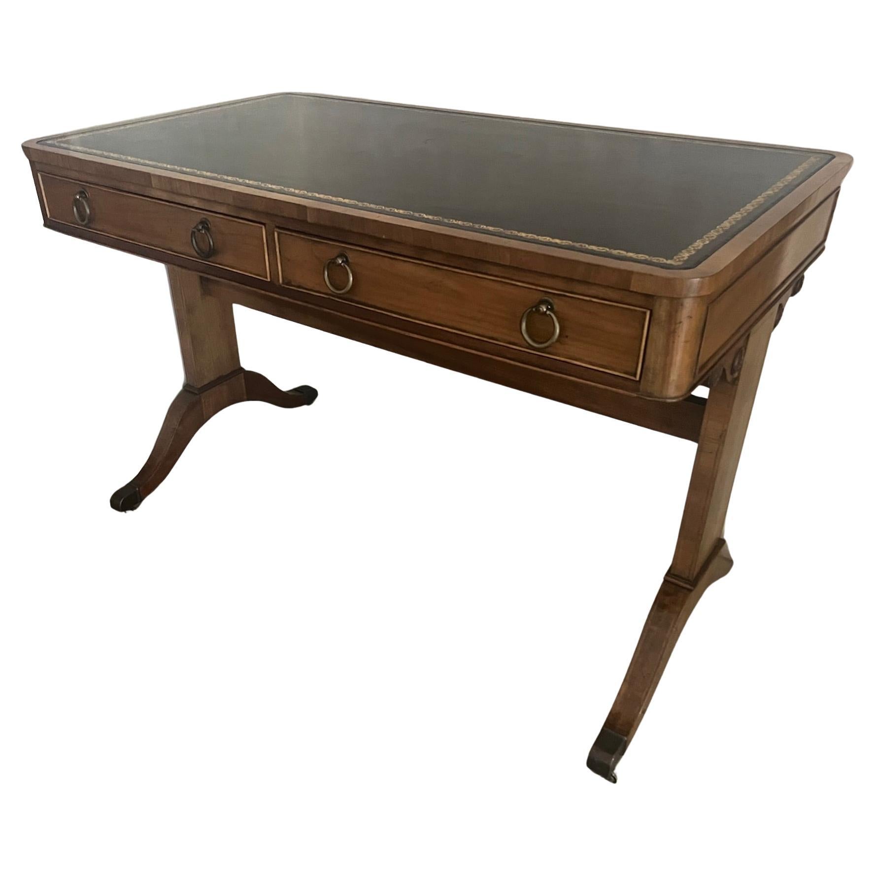 Baker Furniture Company writing table or desk. The table has Regency style details, including carved circles on the side and a black tooled leather top. The feet have brass covers and wheels.
All my furniture can be picked up for free, I am in the
