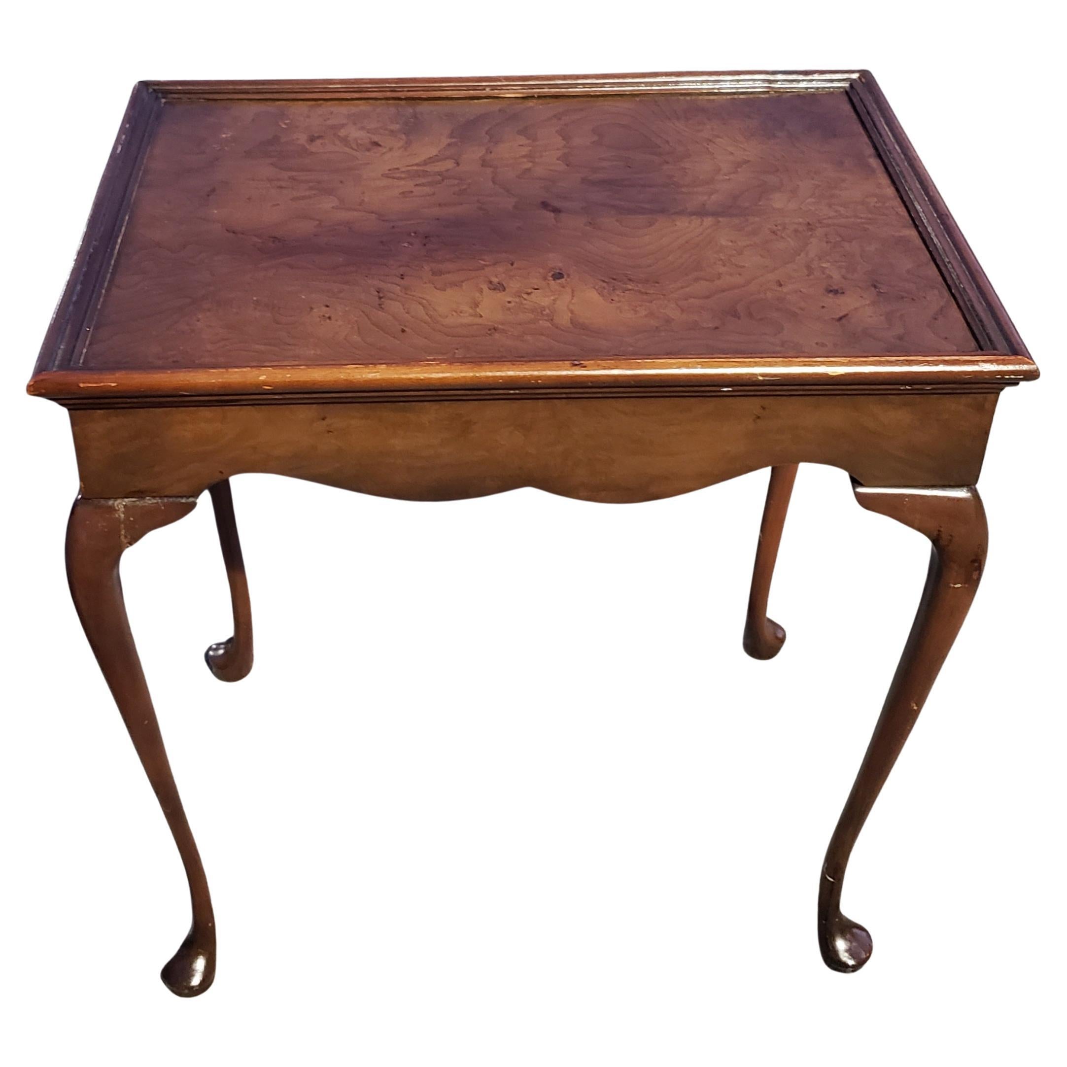 Exquisite Queen Anne side table by Baker Furniture in mahogany and burled walnut top. Good vintage condition with wear co sisters with age and use. 
Measure 14 inches in width, 20 inches  in depth and stand 21.25 inches tall. 