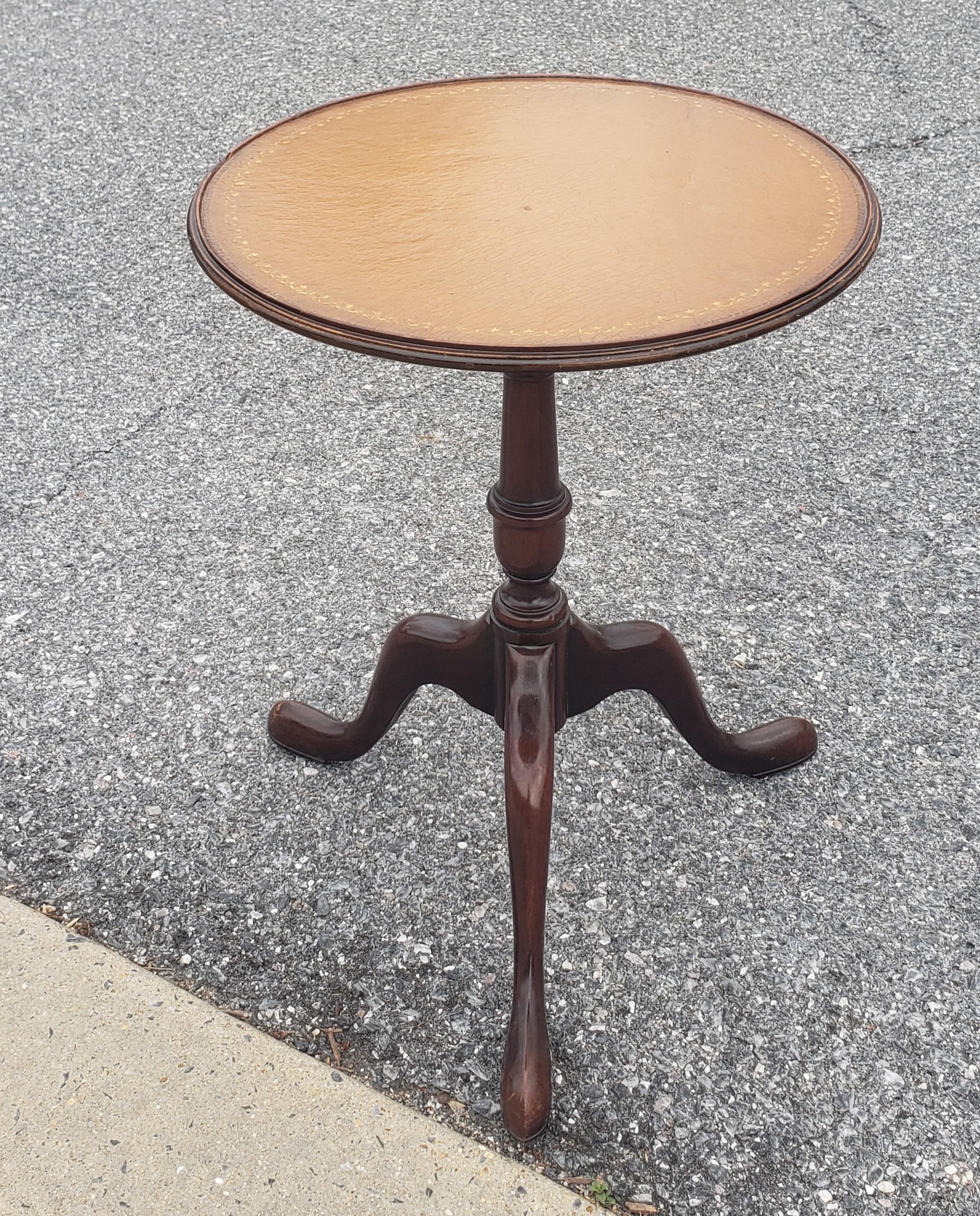 Baker furniture mahogany and tooled leather and stinciled top pedestal candle stand or side table with tripod snake feet. Measures 16