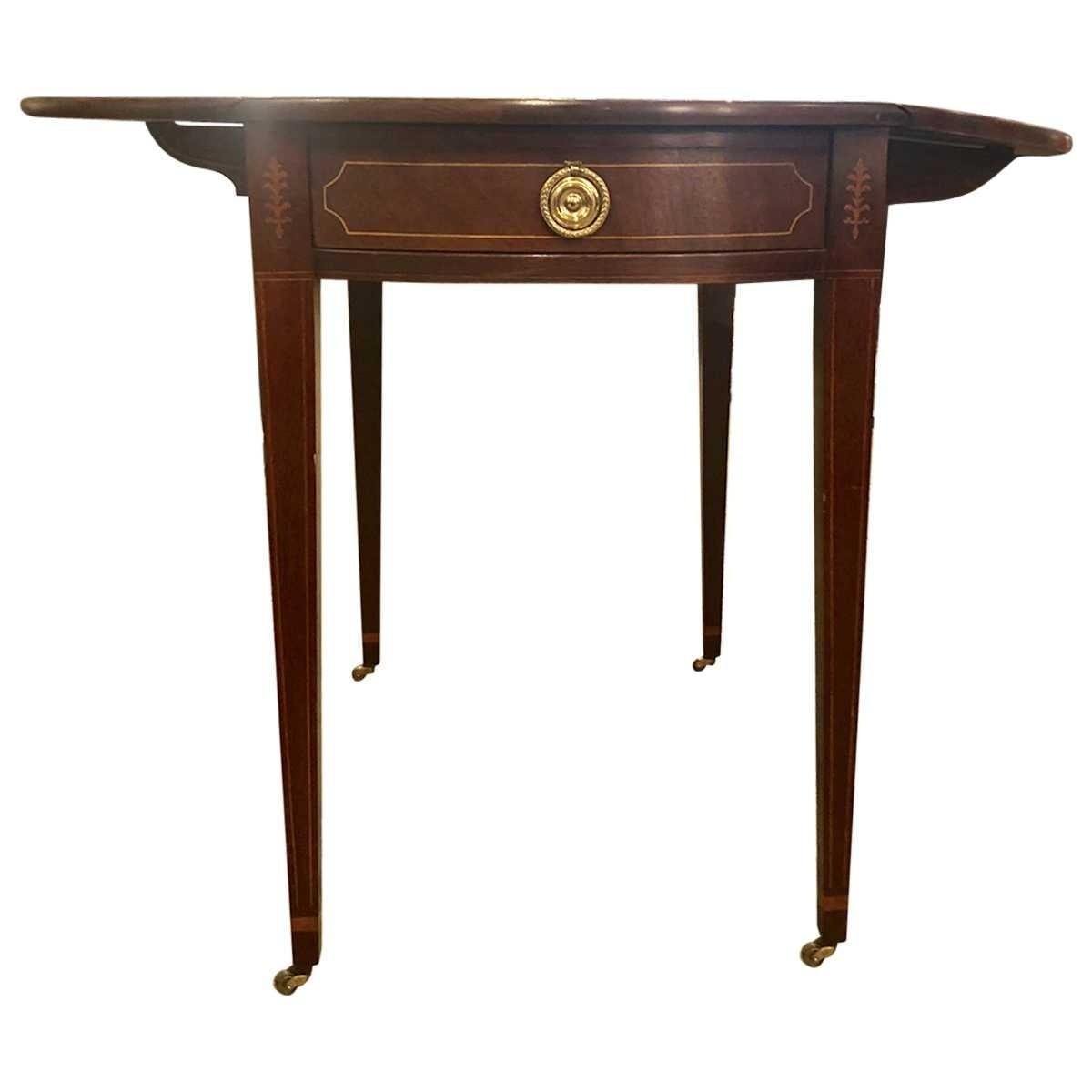 1940s baker mahogany drop-leaf table with brass ring pulls on the drawer. Materials: Mahogany, polished brass
Dimensions:
Width 20