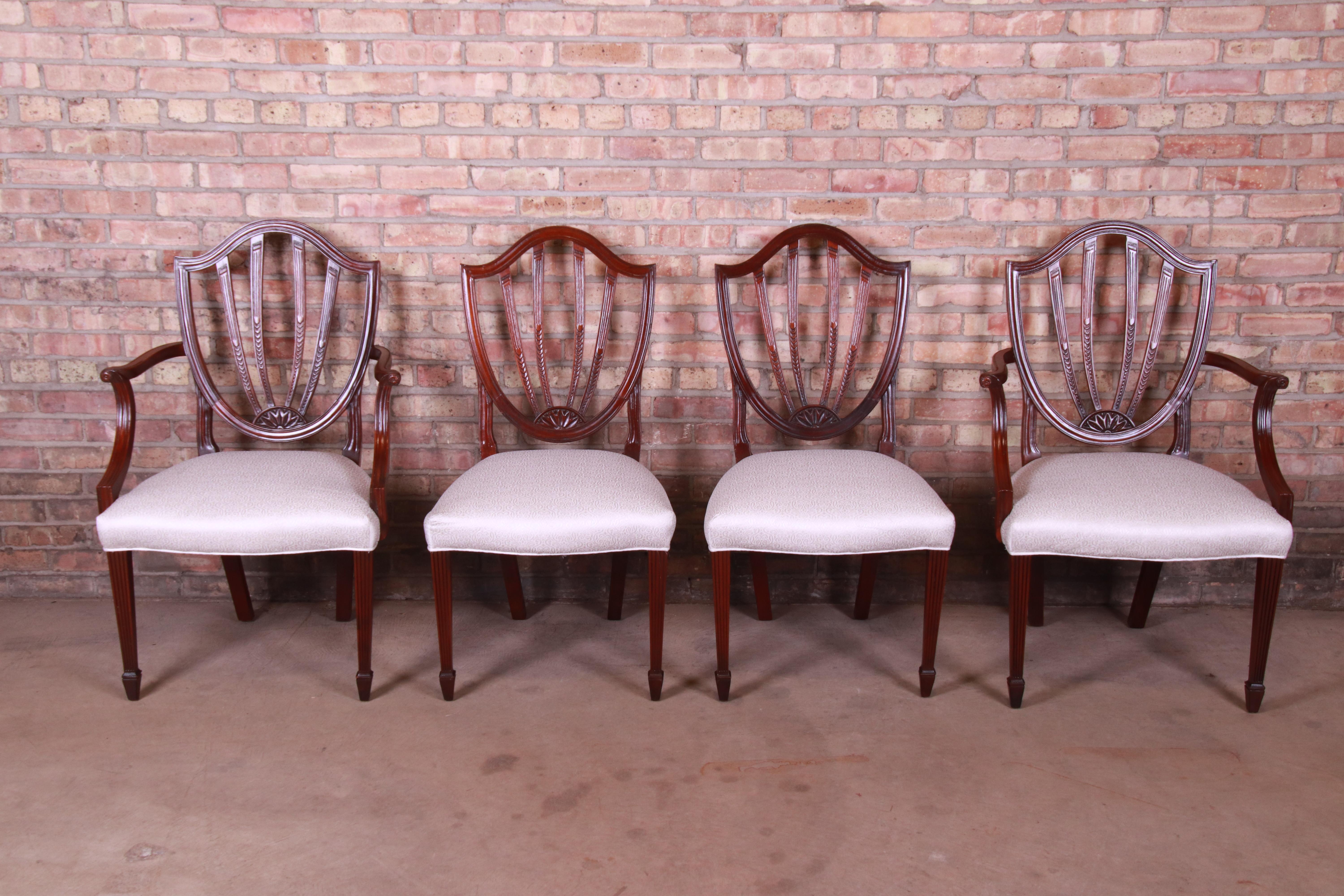 An exceptional set of four Federal or Sheraton style shield-back dining chairs

By Baker Furniture 

USA, circa 1980s

Solid carved mahogany frames, with ivory damask upholstery.

Measures:
Armchairs - 25.63