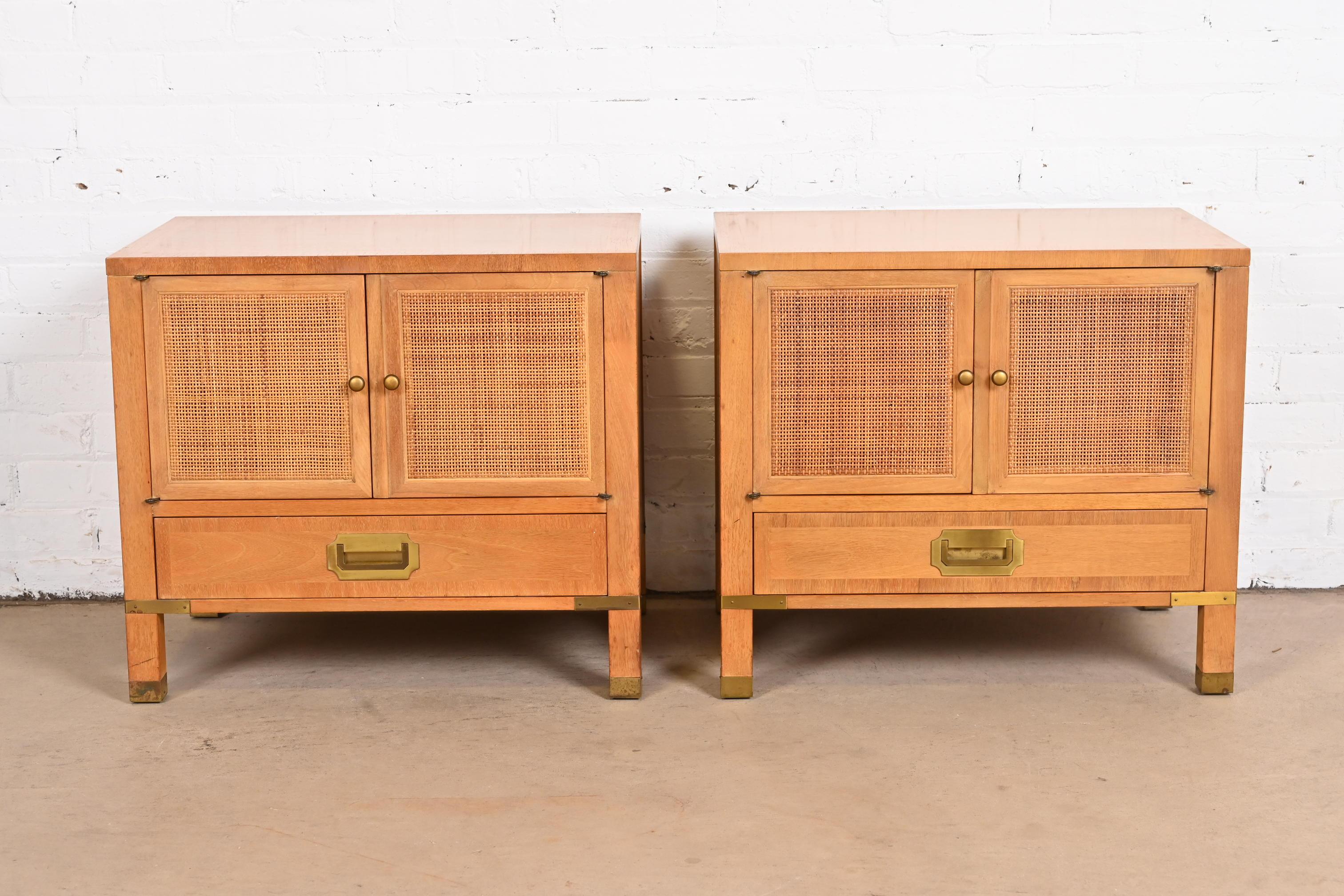 An exceptional pair of Mid-Century Modern Hollywood Regency Campaign nightstands or end tables.

Produced by Grand Rapids Chair Co. for Baker Furniture, 