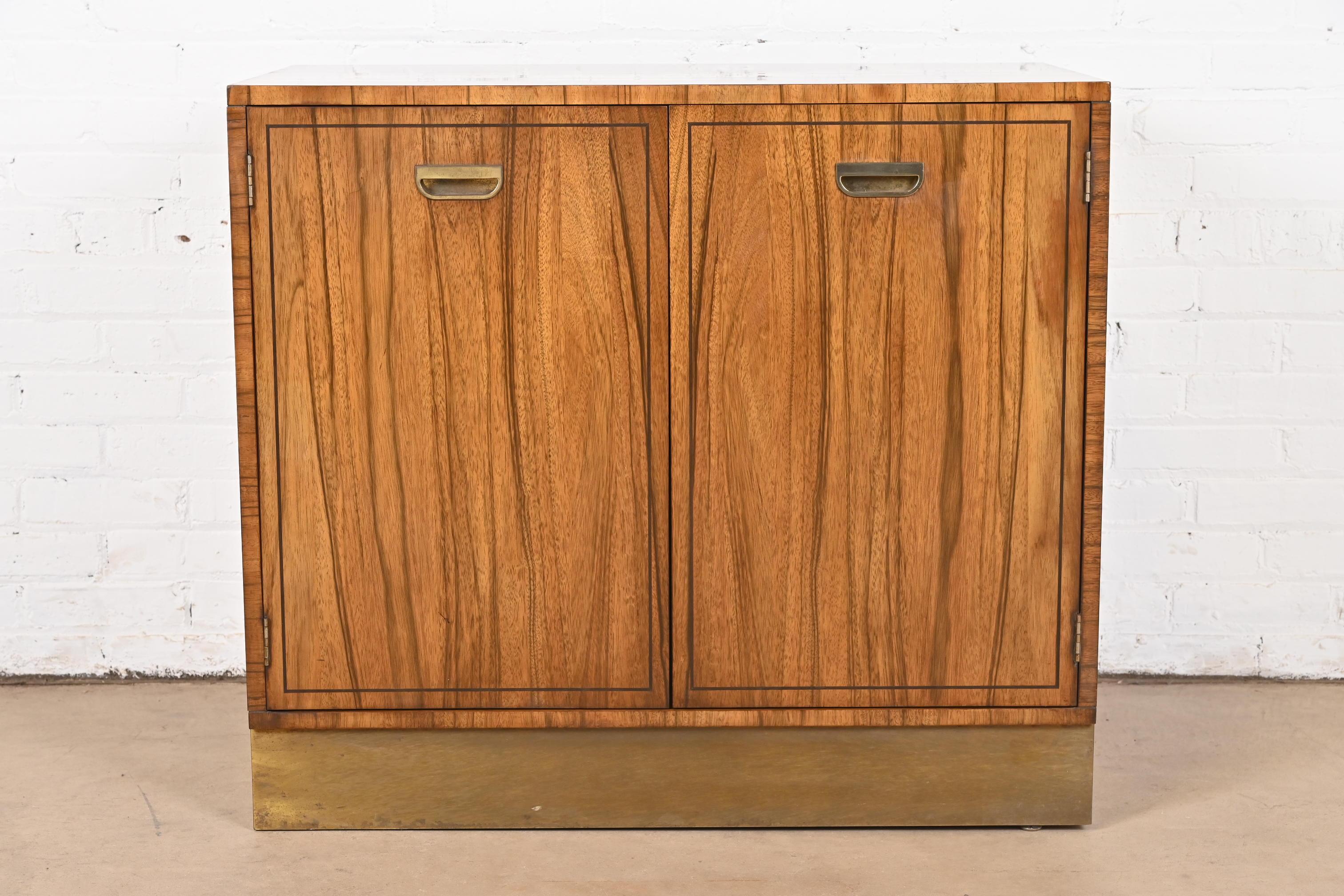 A gorgeous Mid-Century Modern Campaign style bar cabinet

By Baker Furniture

USA, Circa 1960s

Beautiful rosewood, with original brass hardware and brass plinth base.

Measures: 35.13