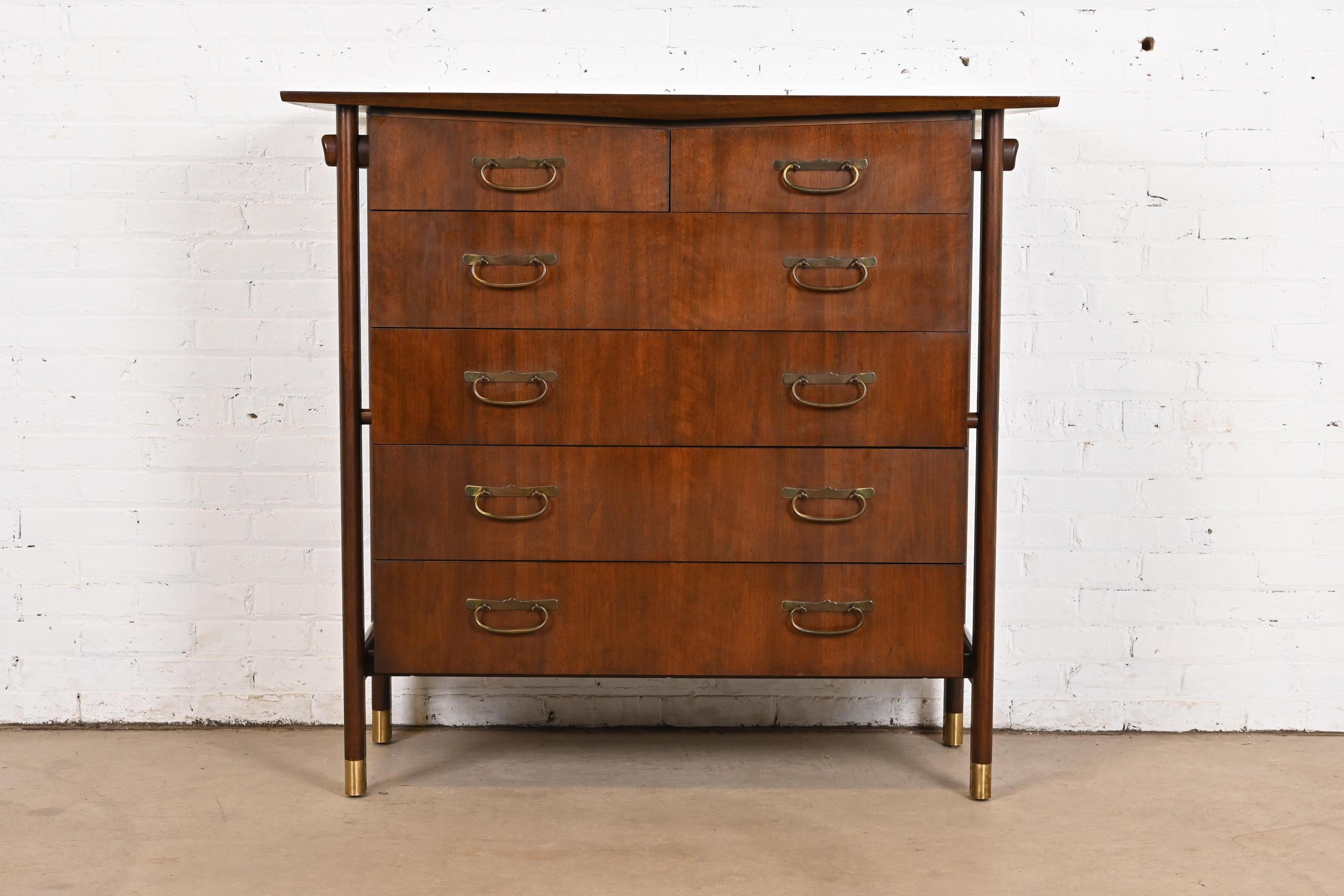 A gorgeous Mid-Century Modern Japanese style six-drawer highboy dresser or chest of drawers

In the manner of George Nakashima

By Baker Furniture

USA, Circa 1960s

Sculpted walnut, with original Japanese-inspired brass hardware and brass-capped