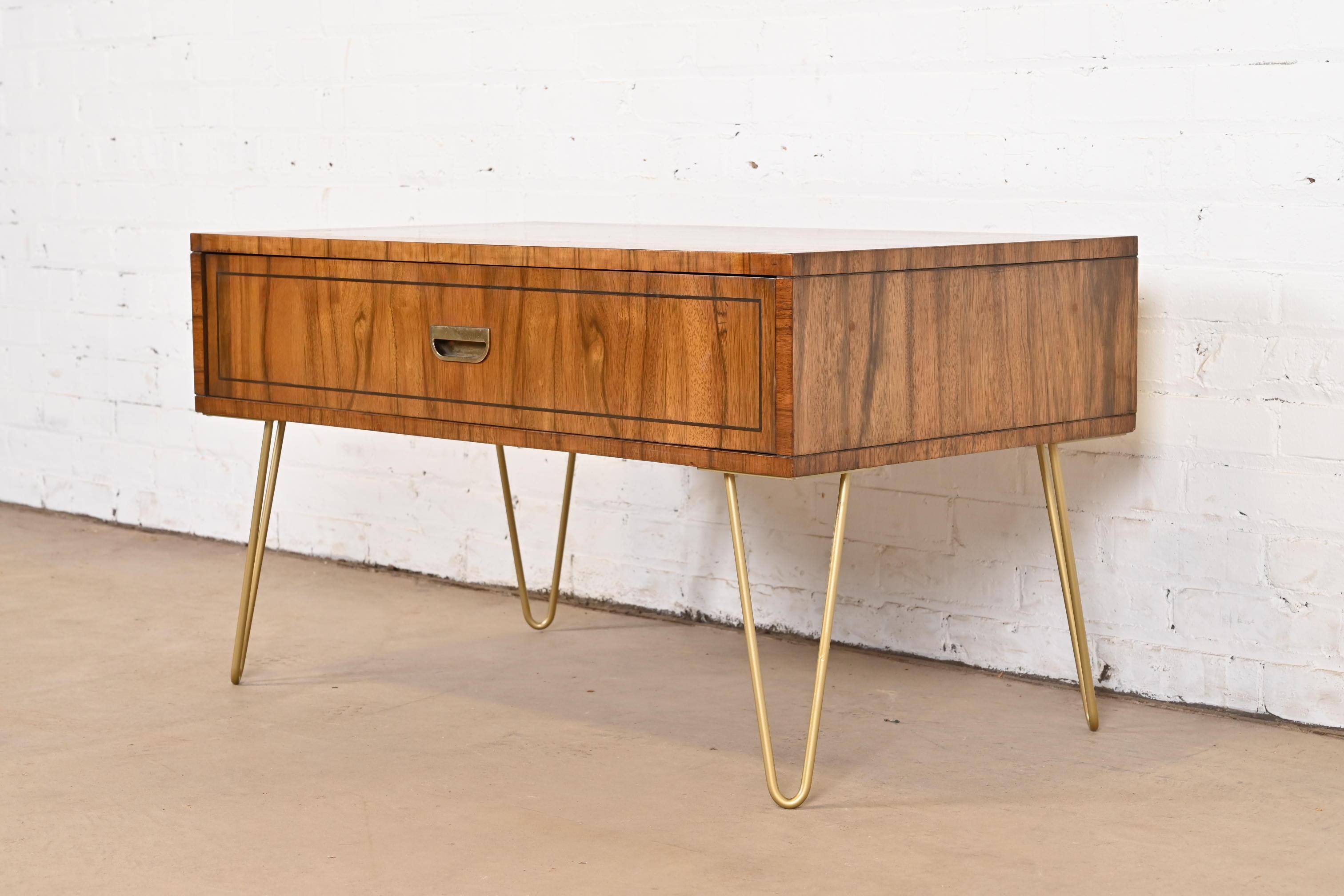 A gorgeous Mid-Century Modern Campaign style coffee table, cocktail table, or low console table

By Baker Furniture

USA, Circa 1960s

Beautiful rosewood, with brass hardware and brass finished steel hairpin legs.

Measures: 35.25