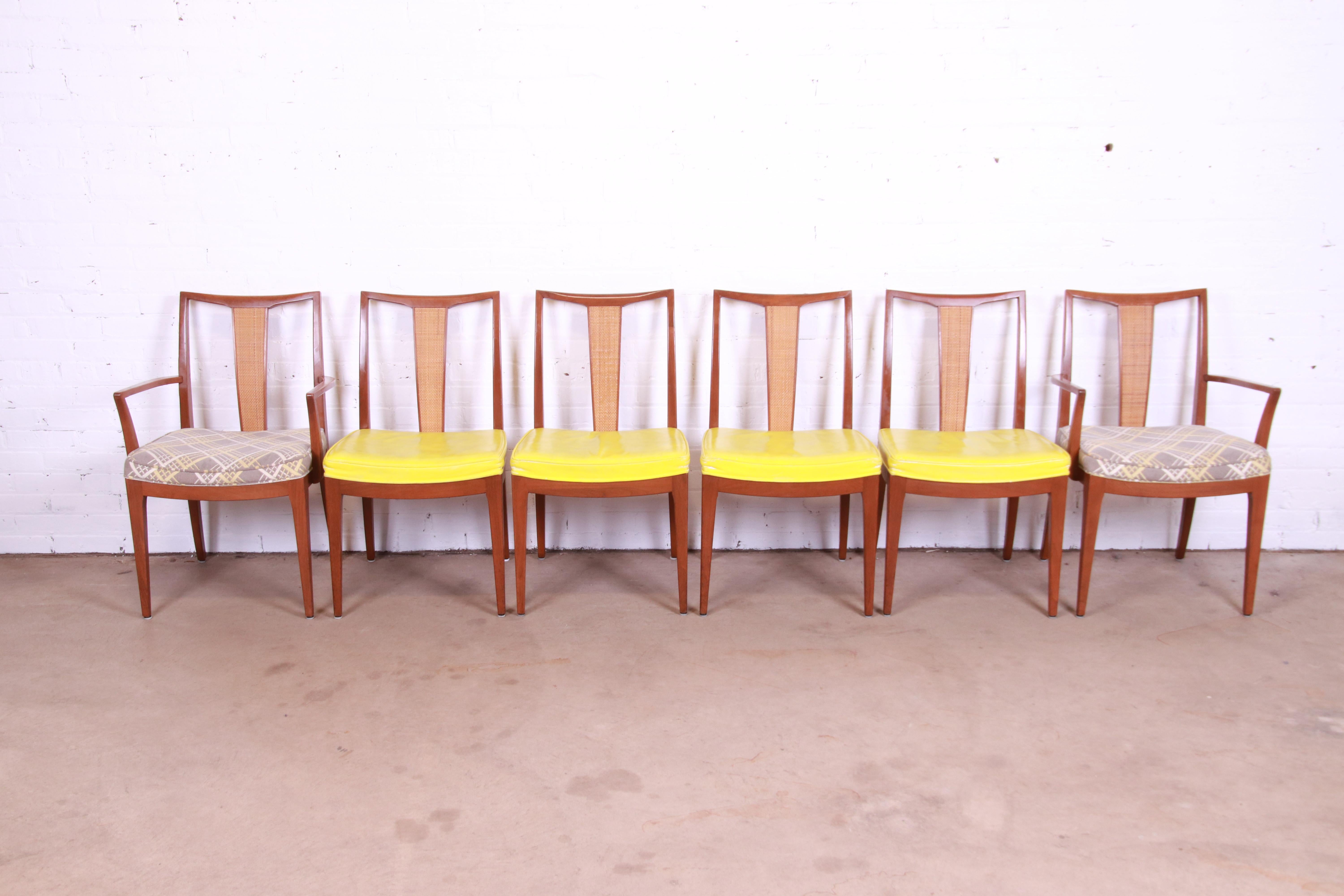 A sleek and stylish set of six mid-century modern dining chairs

By Baker Furniture

USA, Circa 1960s

Sculpted solid walnut frames, with woven rattan backs and upholstered seats.

Measures:
Side chairs - 19