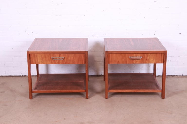 An exceptional pair of Mid-Century Modern nightstands or end tables

By Baker Furniture

USA, mid-20th century

Gorgeous book-matched walnut, with caned lower shelf and chrome hardware.

Measures: 26