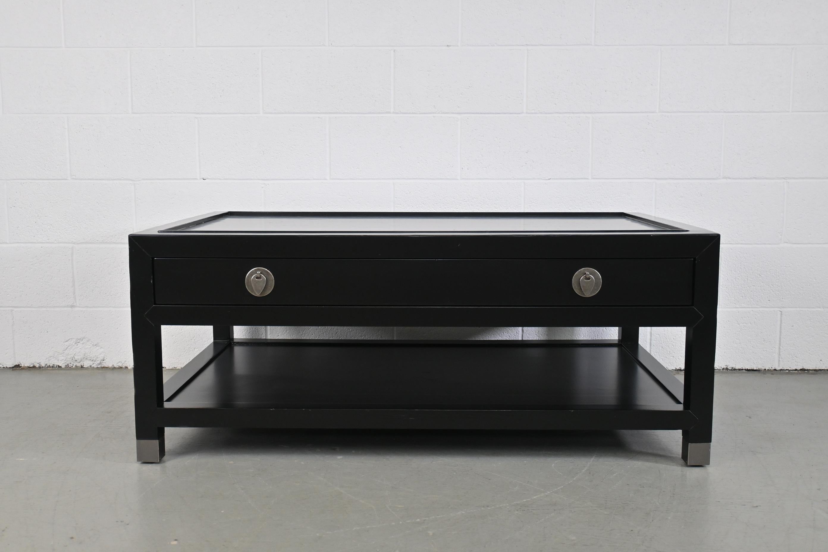 Milling Road Baker Furniture Black Lacquered coffee table.

Baker Furniture, USA, 1990s.

Measures: 50 wide x 30 deep x 20.25 high.

Black lacquered purposefully distressed coffee table with single drawer and brushed silver