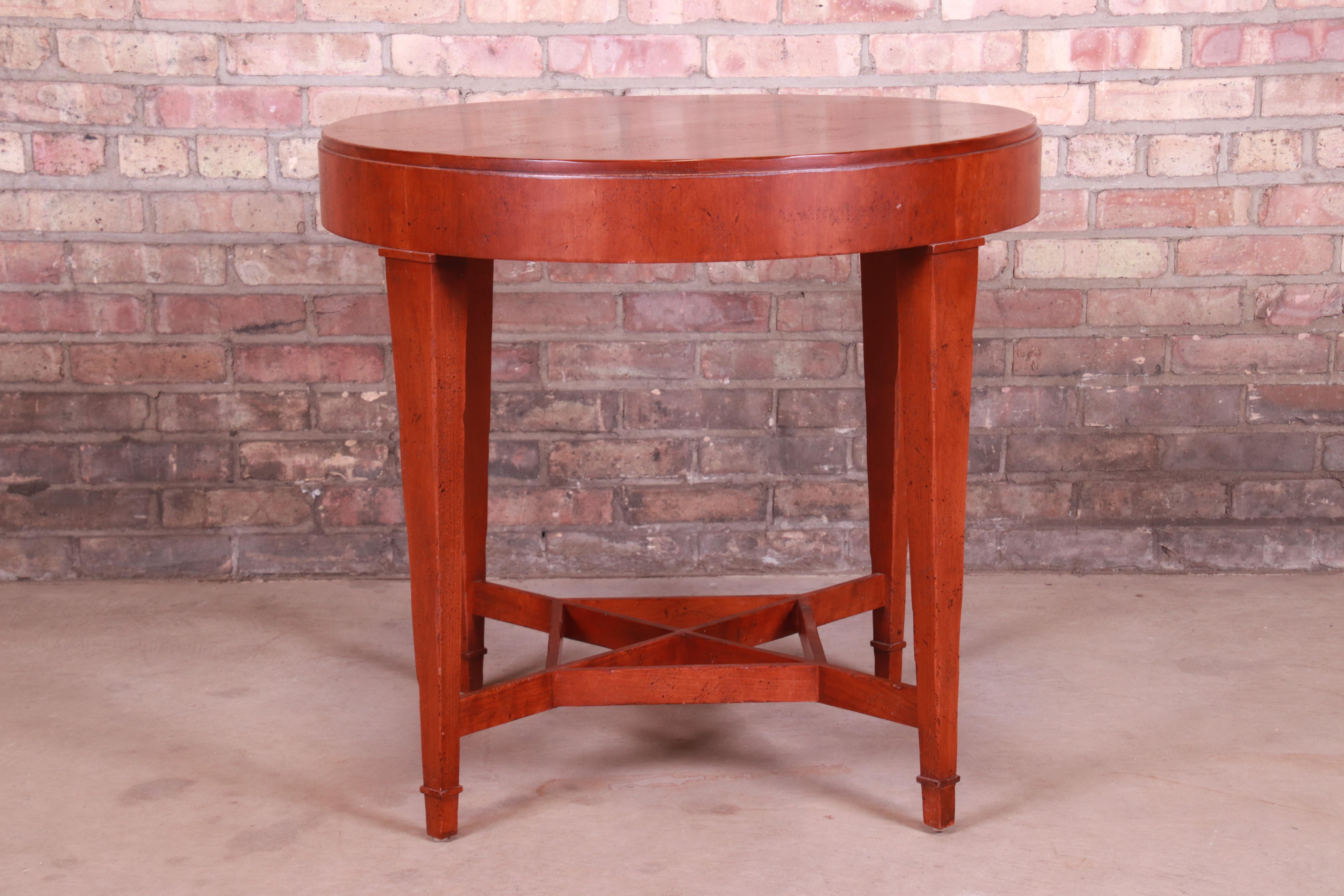 A gorgeous carved cherrywood tea table or occasional side table

By Baker Furniture 