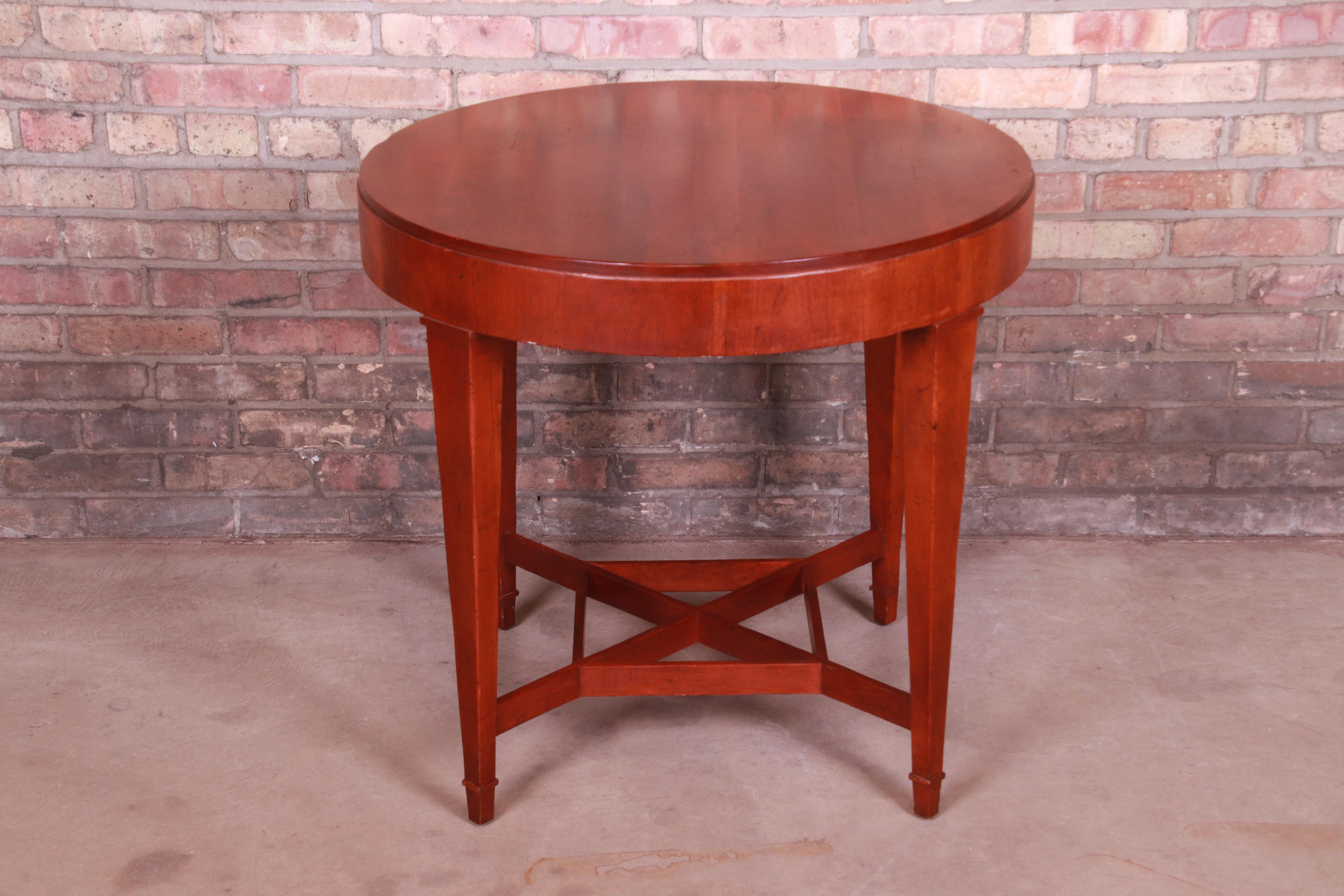 A gorgeous carved cherrywood tea table or occasional side table

By Baker Furniture 