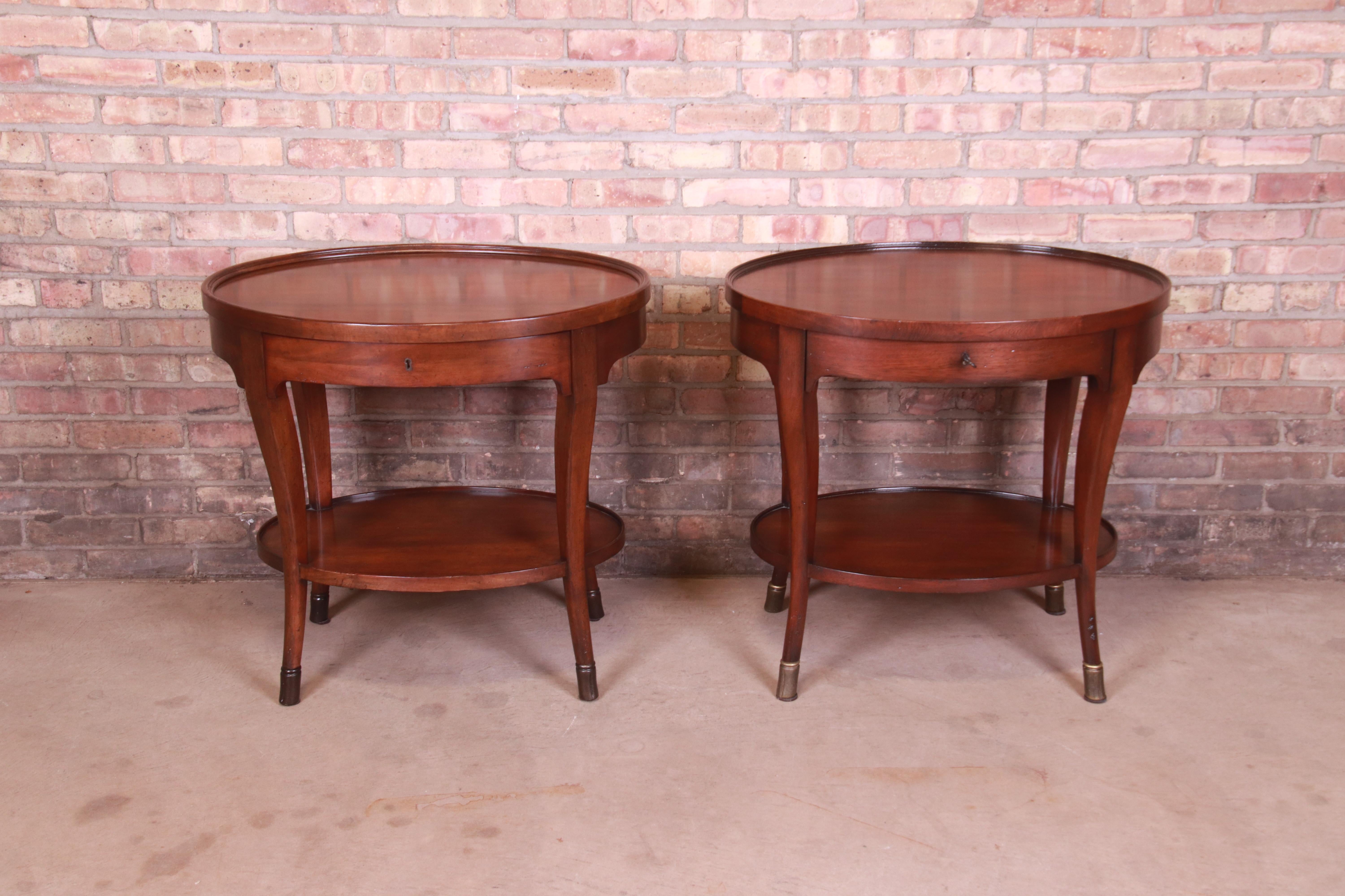 A gorgeous pair of Italian Provincial style two-tier oval walnut side tables or nightstands

By Baker Furniture, 