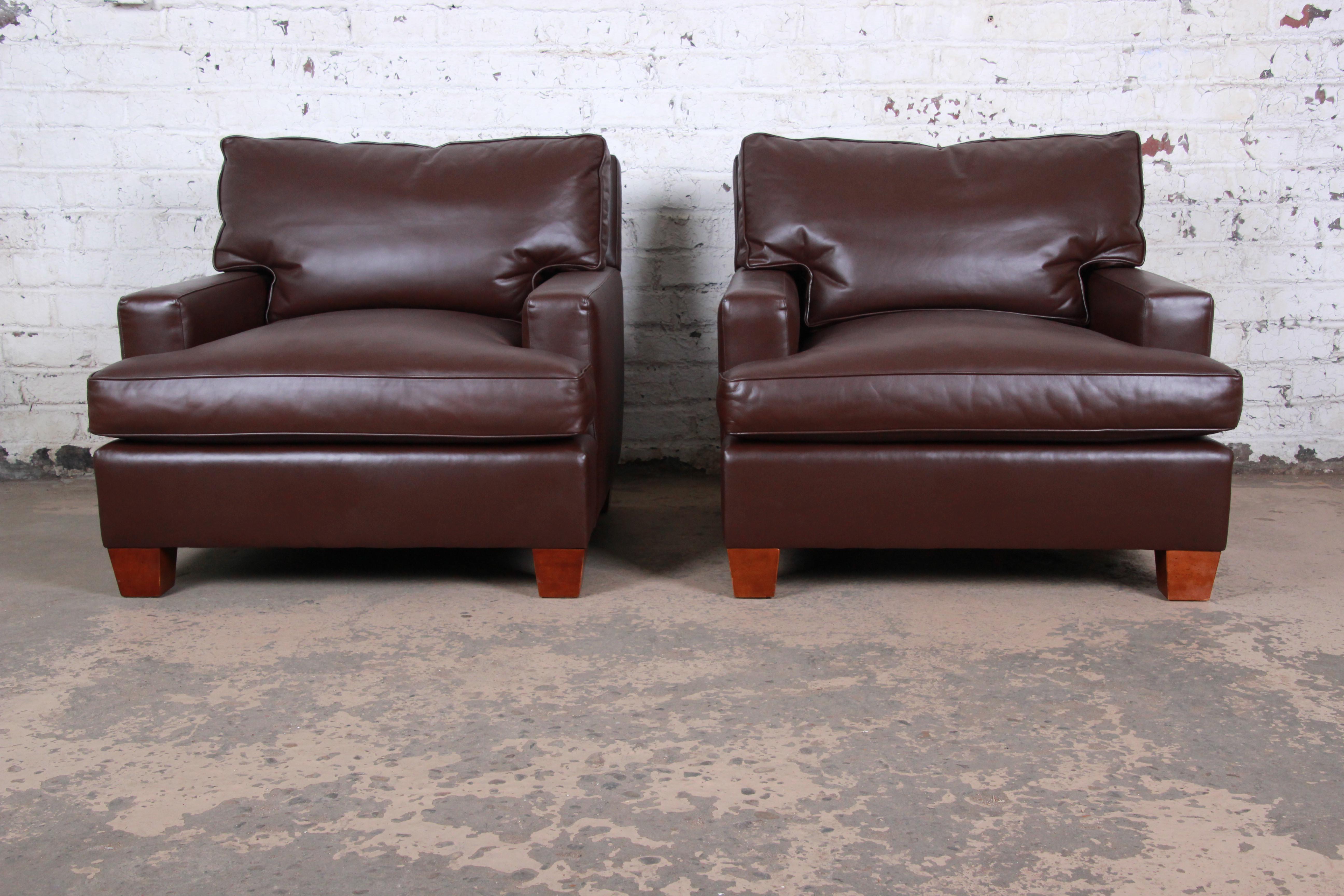A gorgeous pair of modern brown leather club chairs by Baker Furniture. The chairs feature supple high grade dark brown leather with clean lines and a nice contemporary design. The leather has been fully restored and is in pristine condition. The