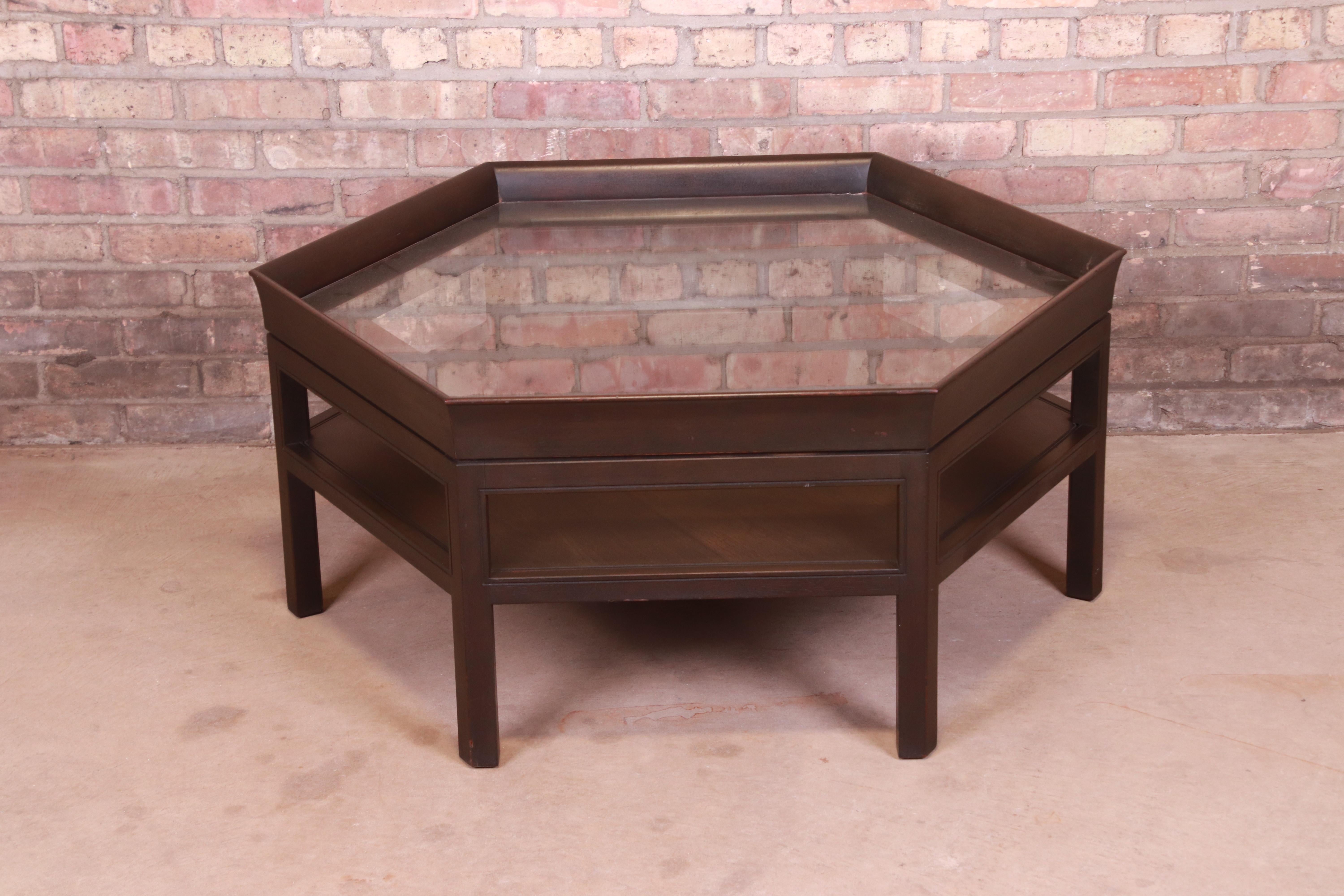 A nice modern two-tier coffee or cocktail table

By Baker Furniture,

USA, late 20th century

Mahogany, with inset glass top.

Measures: 42.13