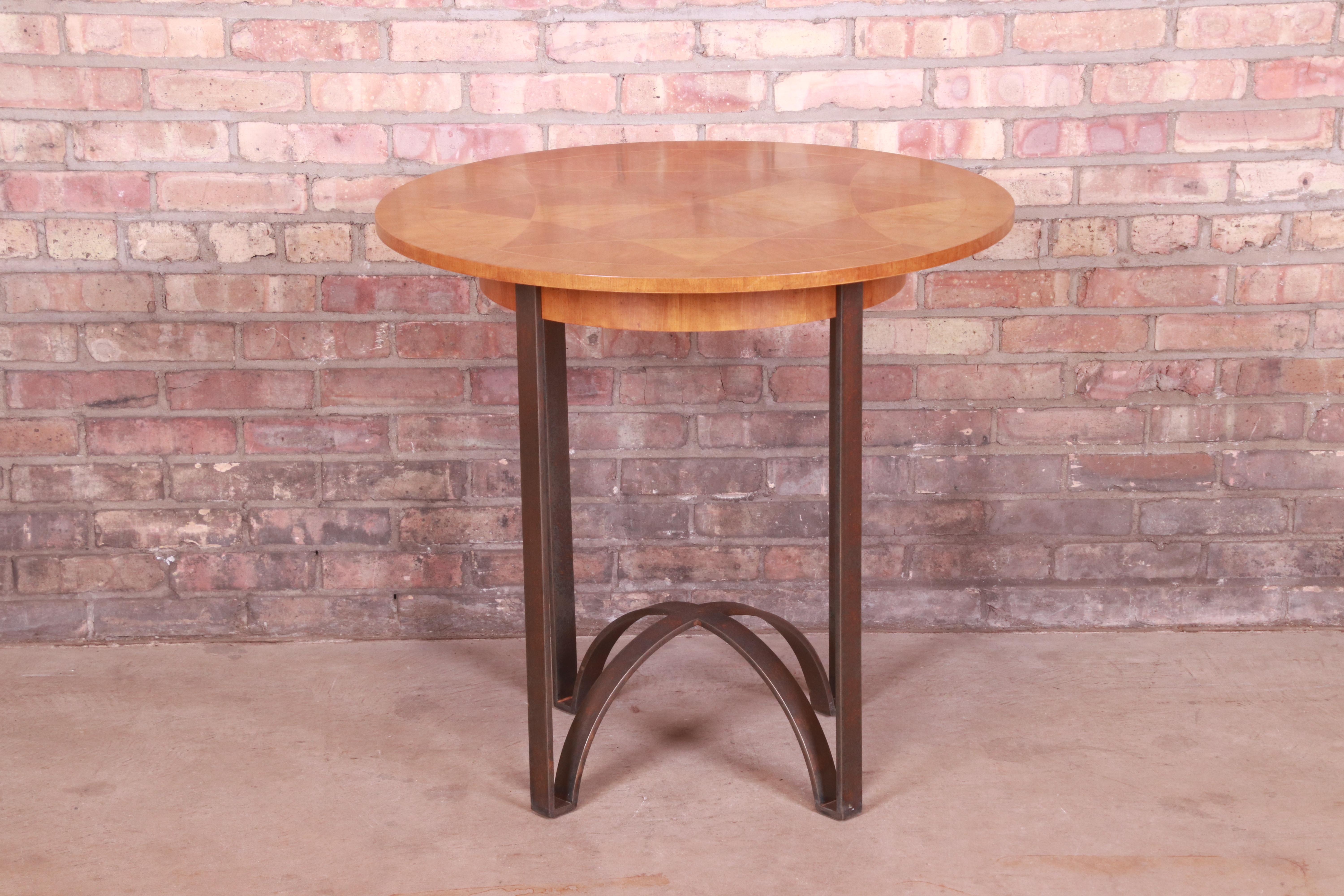 A gorgeous modern tea table or center table

By Baker Furniture

USA, Circa 1990s

Cherry wood with inlaid starburst design, and sculpted bronze finished metal base.

Measures: 31