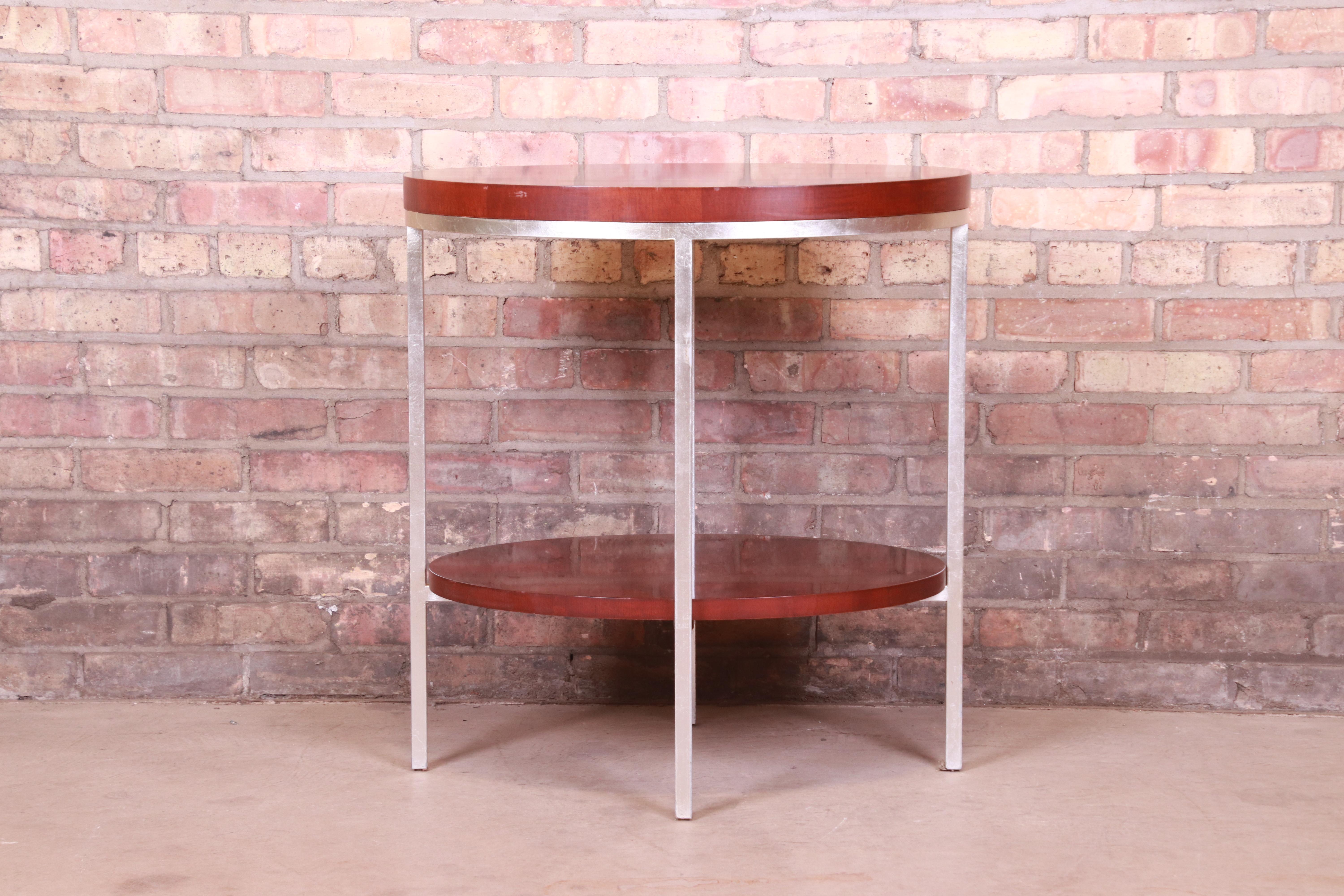 A gorgeous modern two-tier occasional side table

By Baker Furniture

USA, Circa 1990s

Mahogany, with steel legs.

Measures: 26