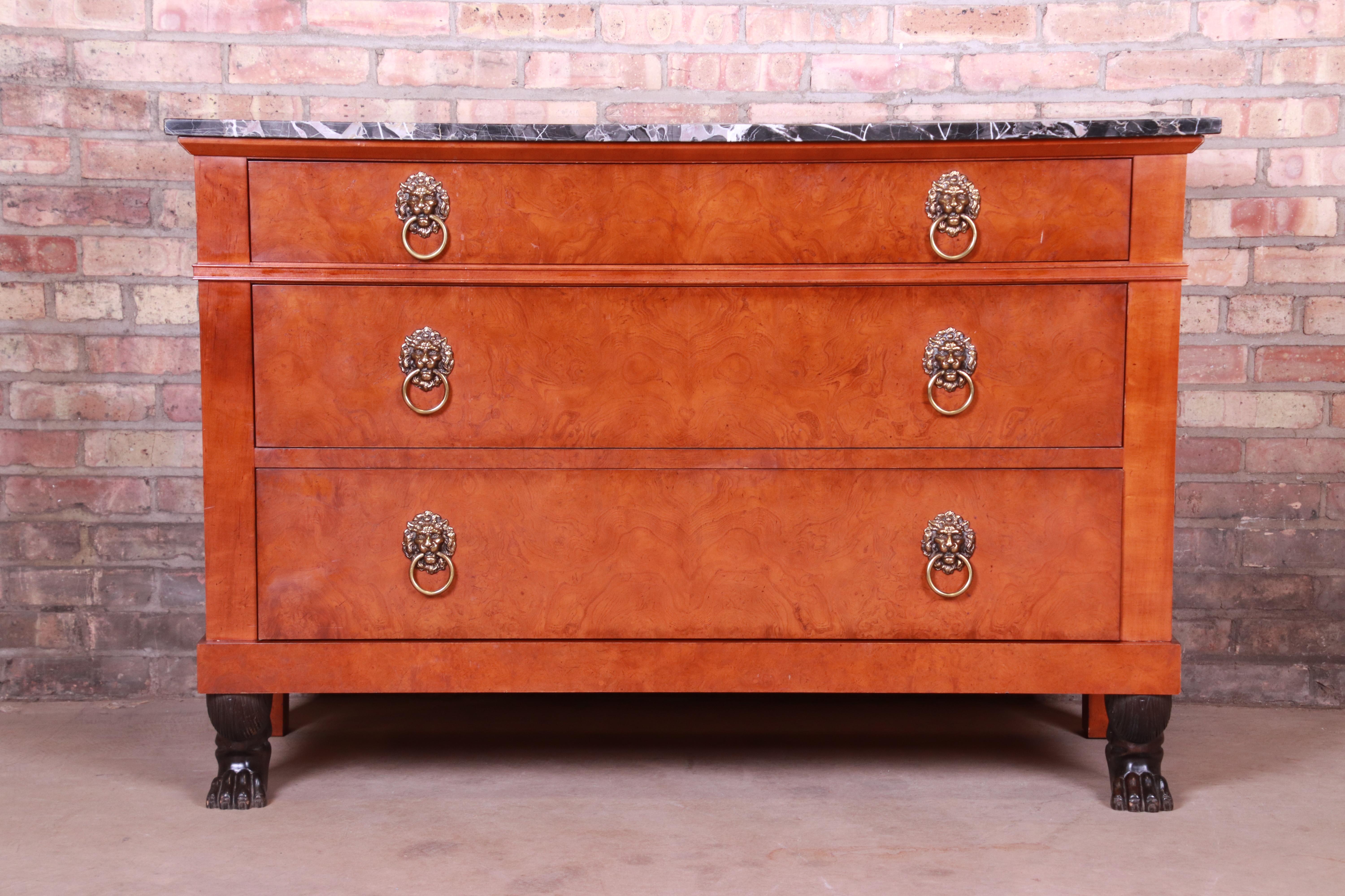 An exceptional neoclassical style commode or chest of drawers

Procured from the historic Waldorf Astoria Hotel in New York City

By Baker Furniture

USA, 20th century

Burl wood, with original lion head brass hardware, ebonized paw feet,