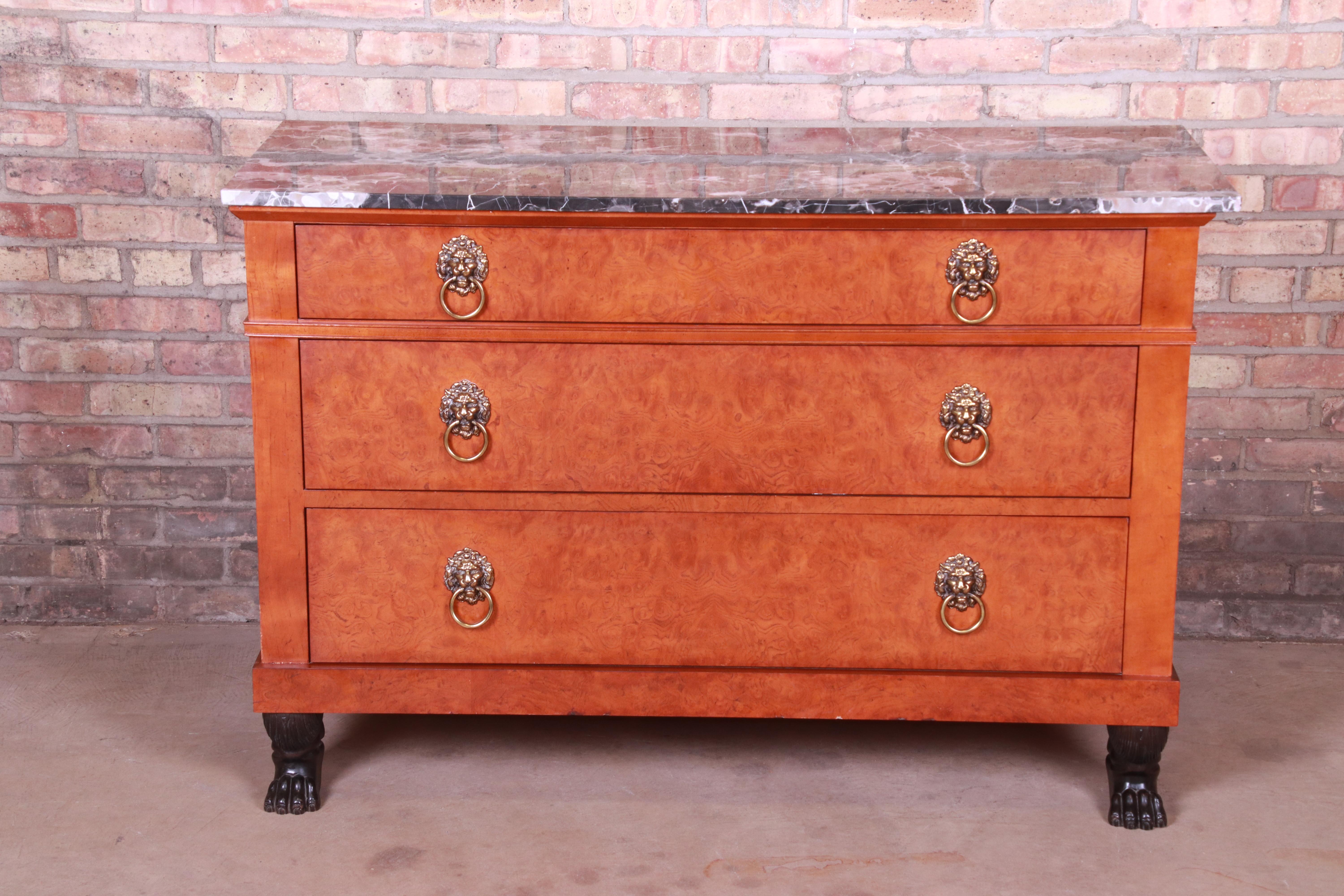 An exceptional neoclassical style commode or chest of drawers

Procured from the historic Waldorf Astoria Hotel in New York City

By Baker Furniture

USA, 20th century

Burl wood, with original lion head brass hardware, ebonized paw feet, and marble