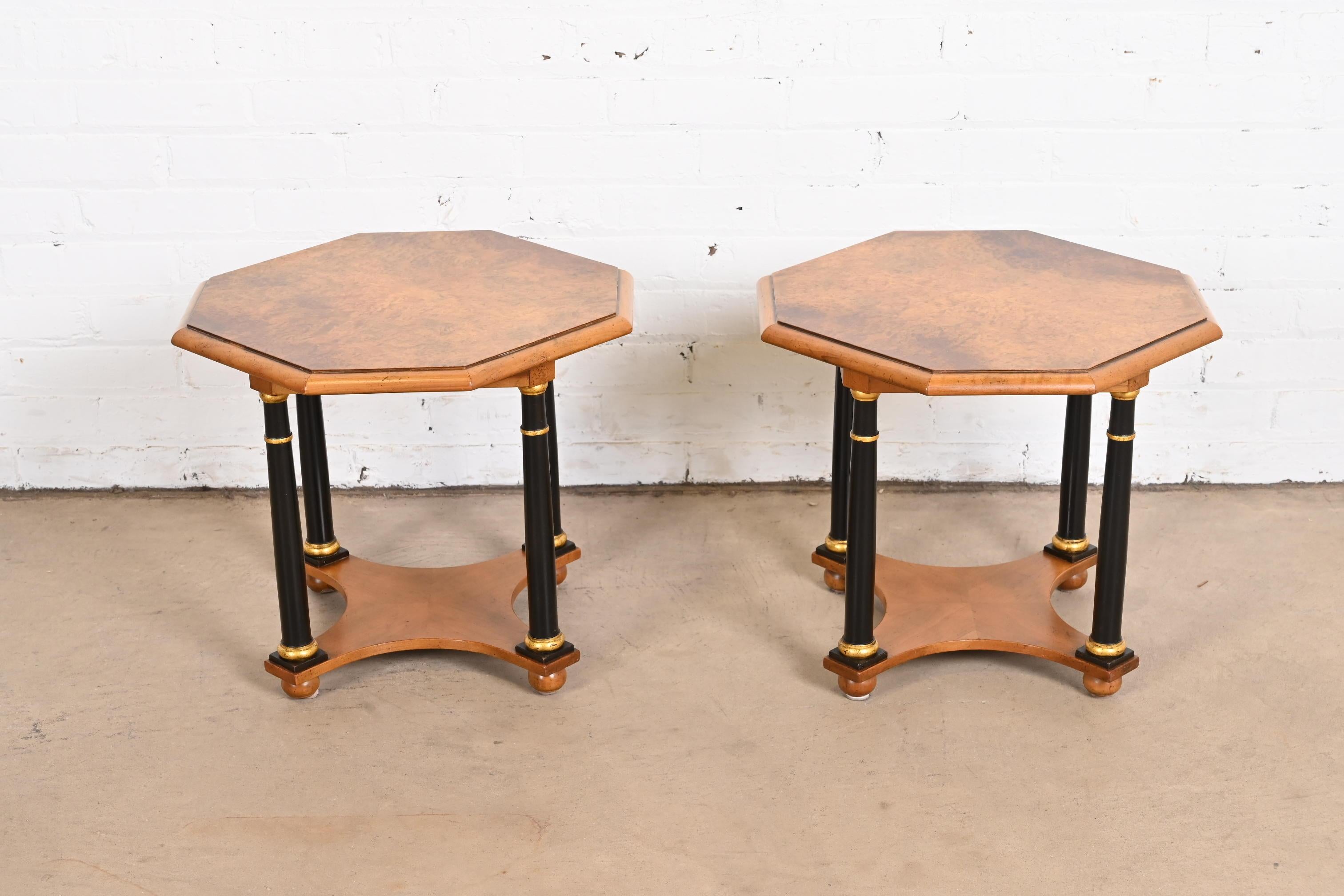 An exceptional pair of neoclassical or Empire style tea tables or occasional side tables.

By Baker Furniture

USA, circa 1960s

Gorgeous burled walnut, with ebonized and gold gilt column legs.

Measures: 18