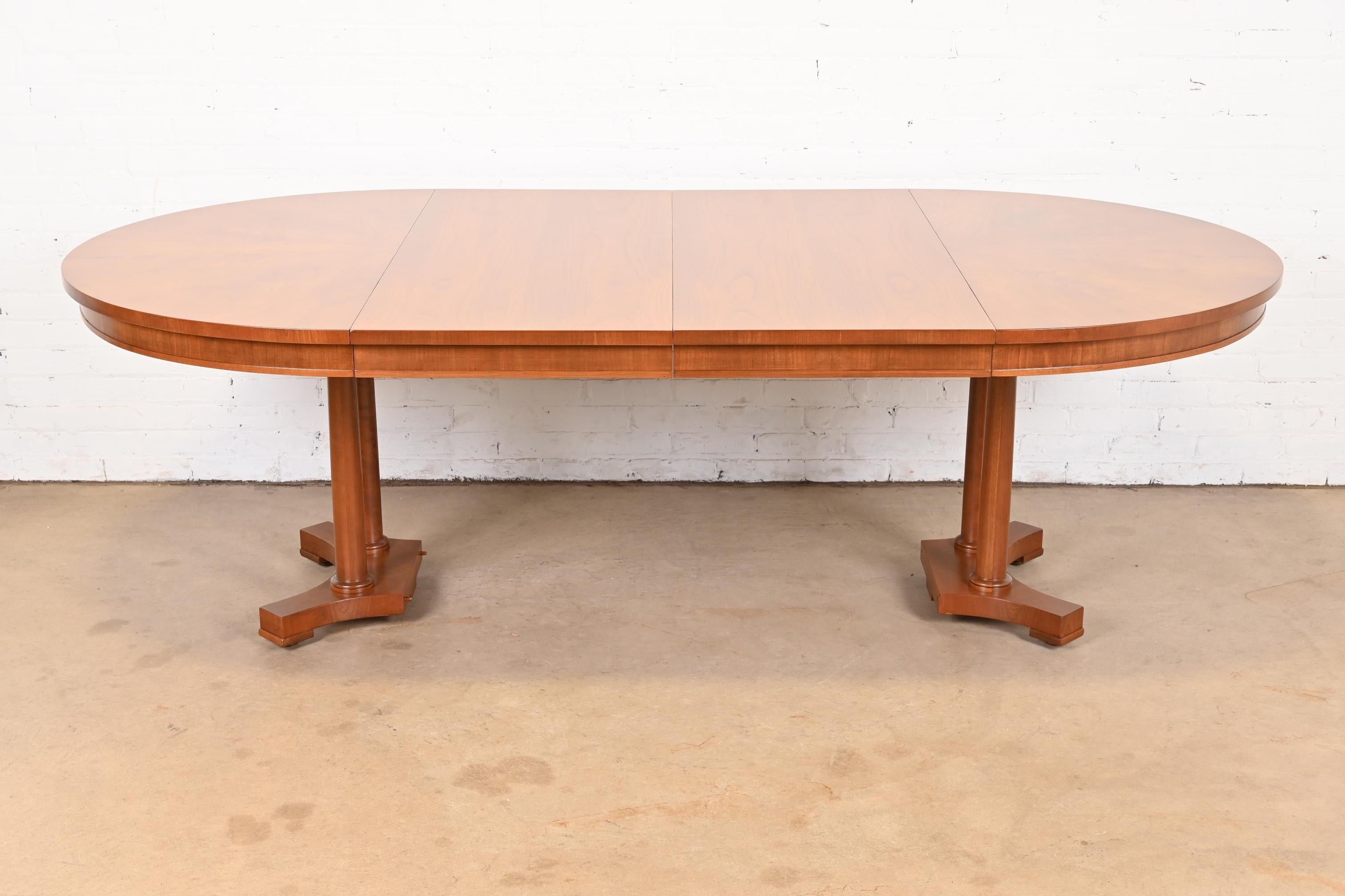 A gorgeous Neoclassical, Empire, or Regency style extension dining table

By Baker Furniture

USA, Circa 1960s

Beautiful book-matched cherry wood top, with solid cherry columned pedestals.

Measures: 50