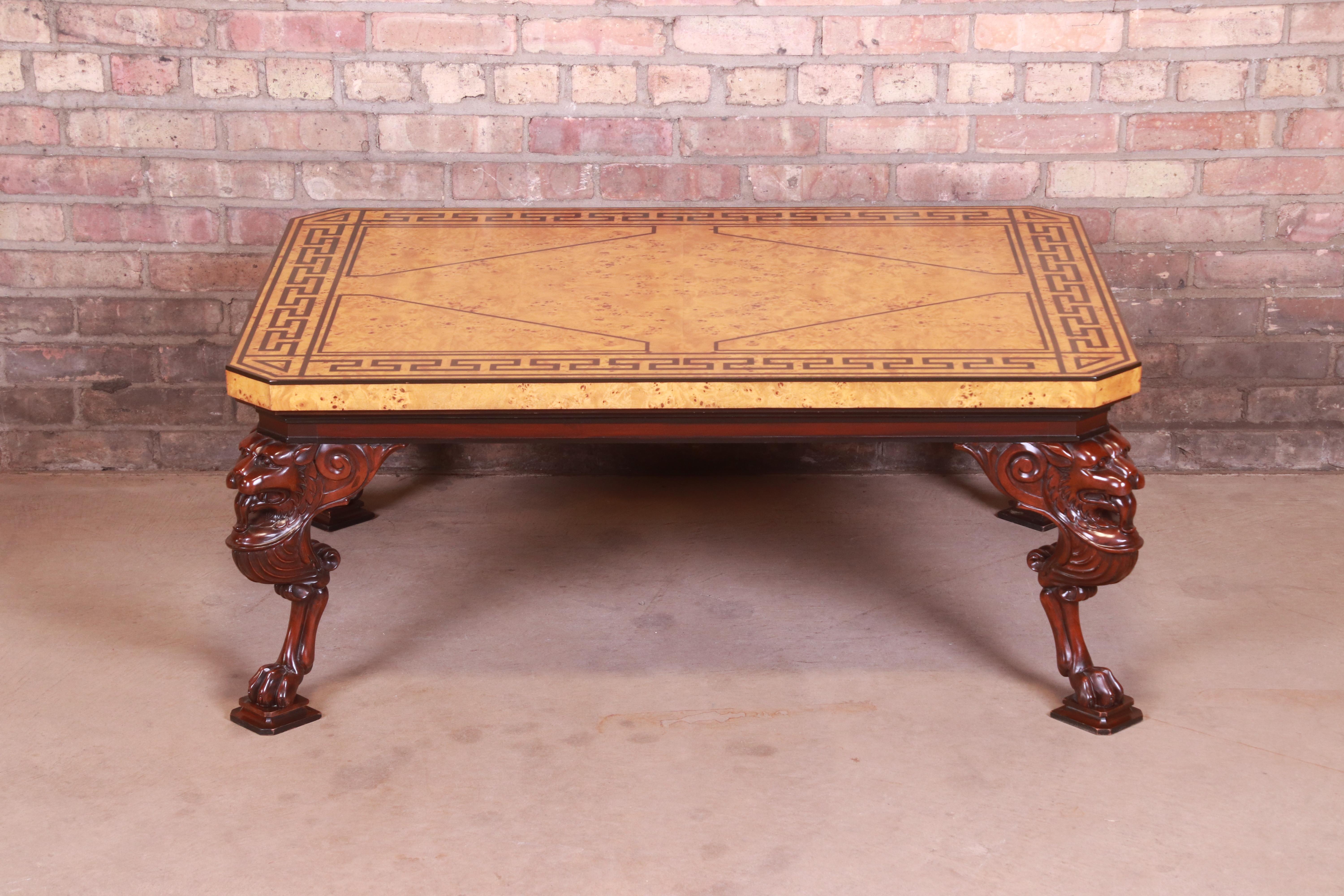 An outstanding neoclassical style coffee or cocktail table

By Baker Furniture

USA, late 20th century

Burled olive wood top with ebonized Greek Key design, on carved solid mahogany lion form legs terminating in paw feet.

Measures: 43.5