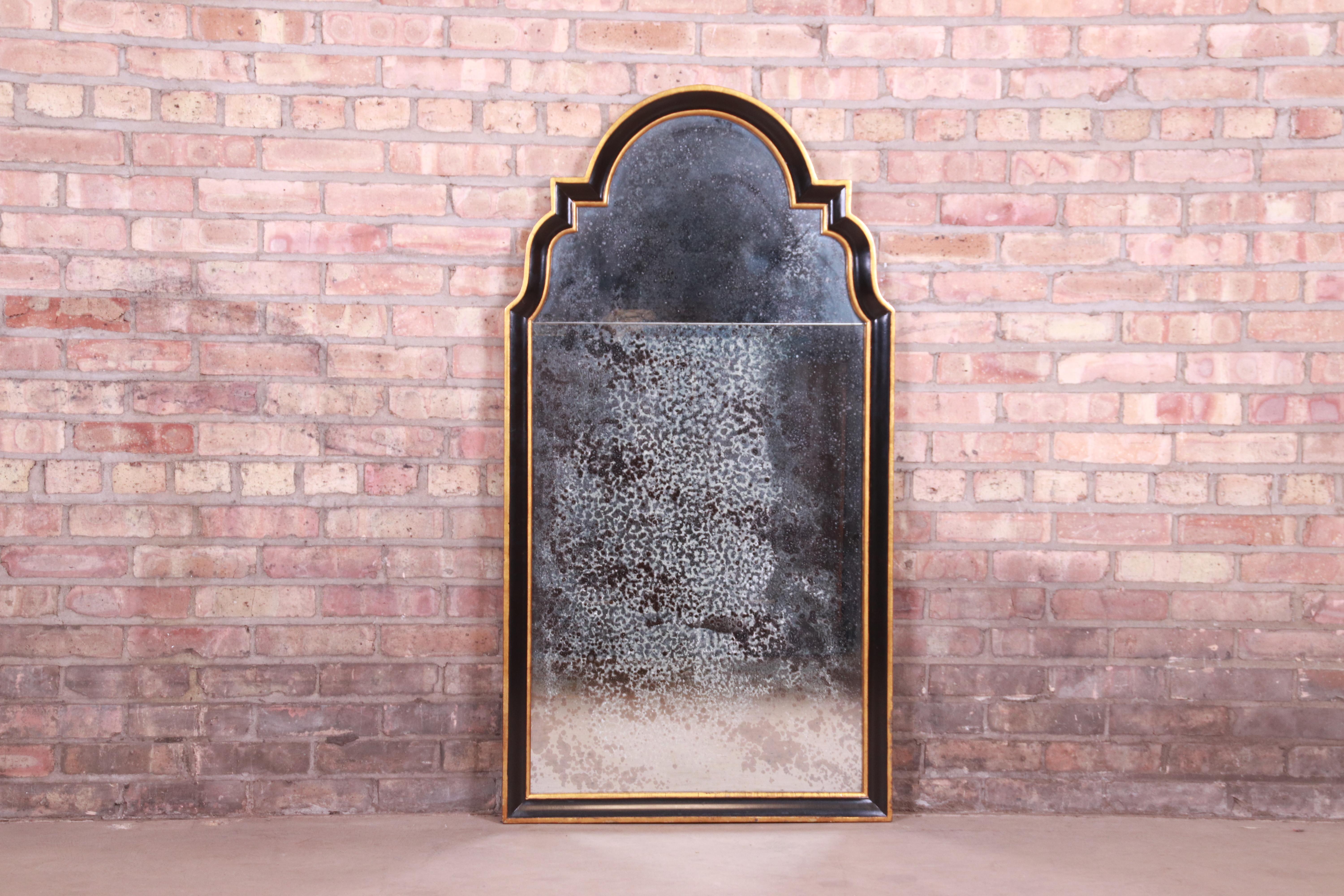 A gorgeous Neoclassical style framed wall mirror

By Baker Furniture

USA, late 20th century

Ebonized wood frame, with gold gilt accents.

Measures: 26.5