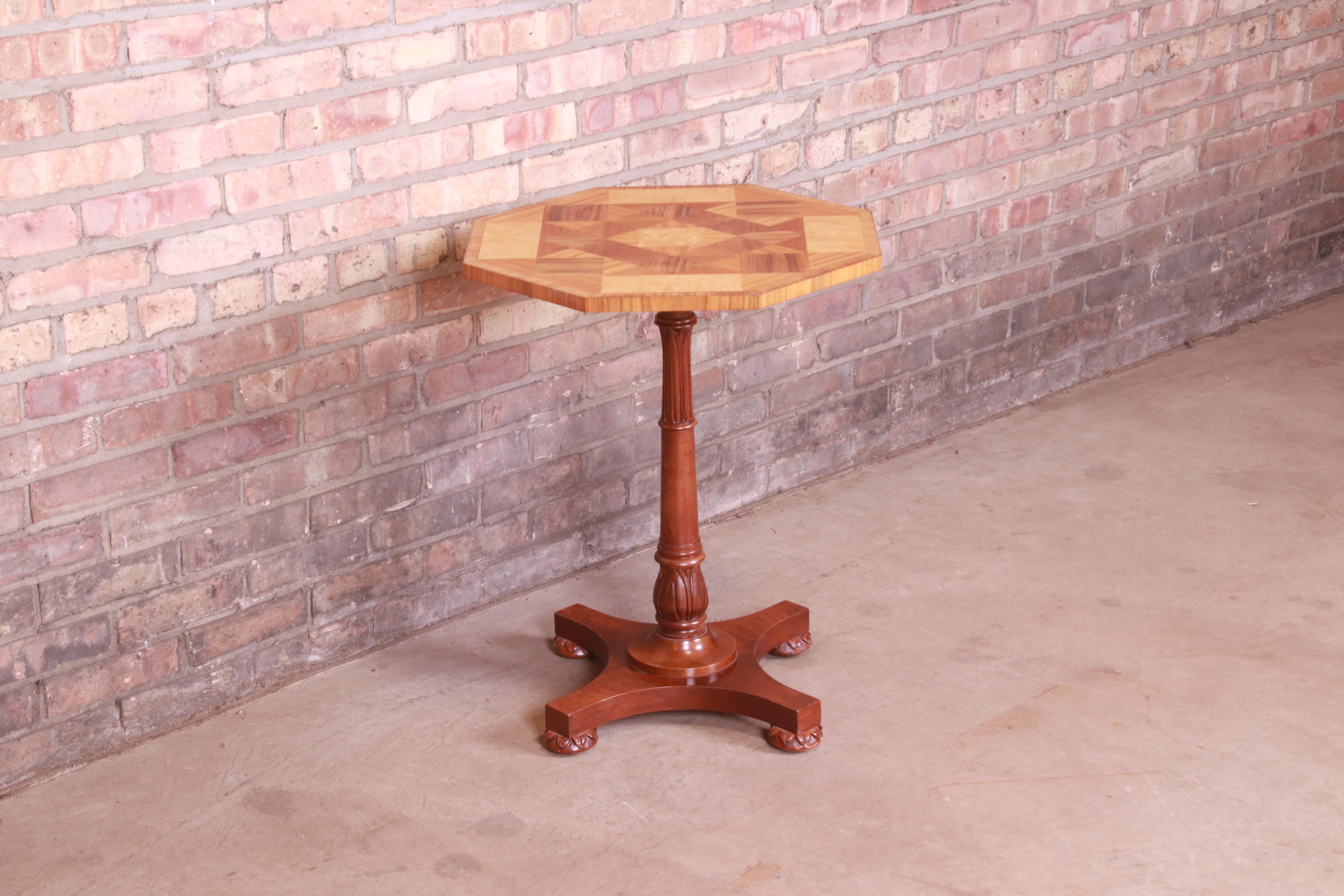 An exceptional neoclassical or Regency style pedestal tea table or occasional side table

By Baker Furniture

USA, Circa 1980s

Carved cherry wood pedestal, with outstanding inlaid marquetry top in walnut, satinwood, and burled olive