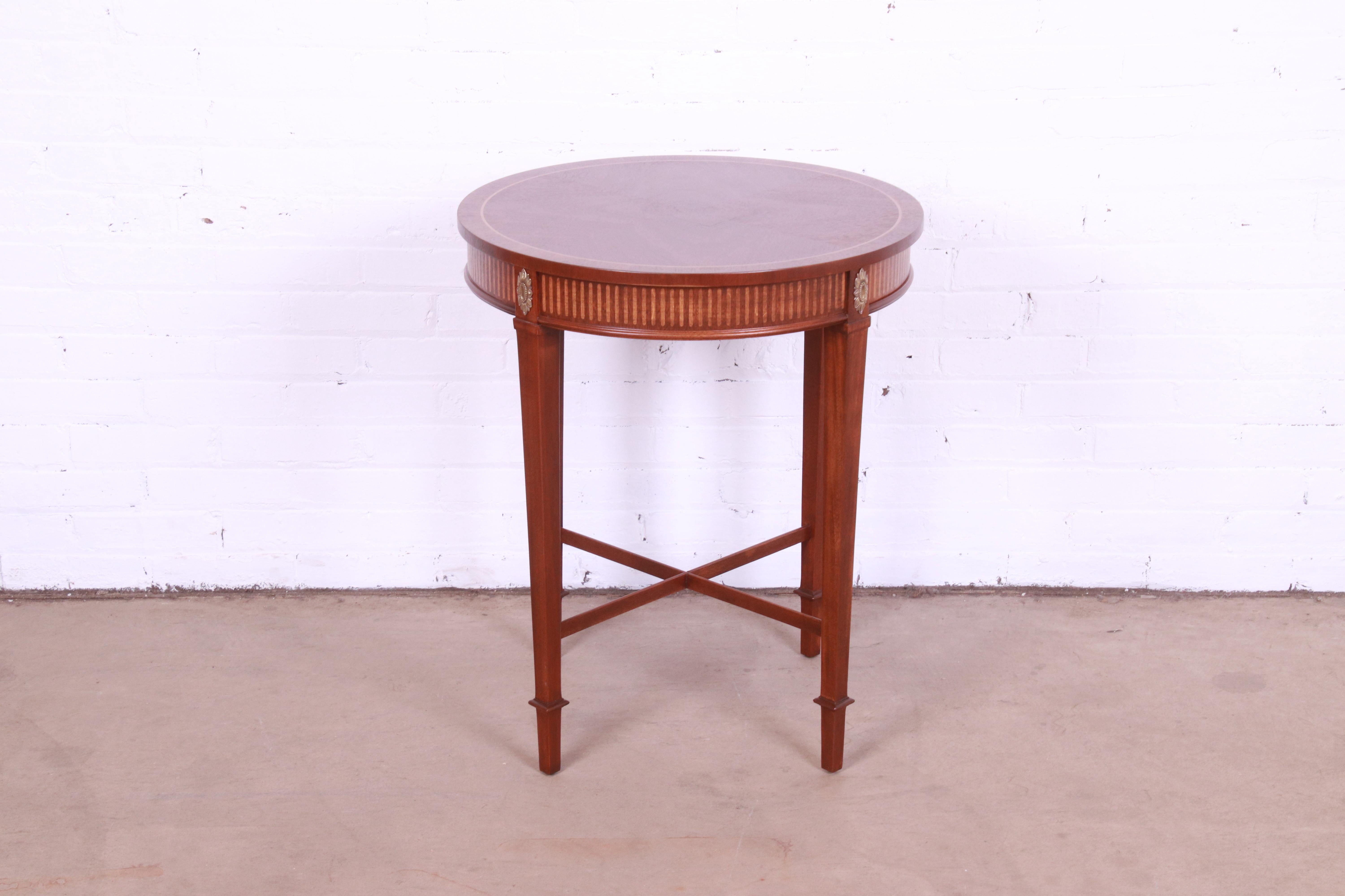 A gorgeous Neoclassical style occasional side table or tea table

By Baker Furniture

USA, Circa 1980s

Mahogany, with satinwood inlay and mounted brass ormolu.

Measures: 23.25